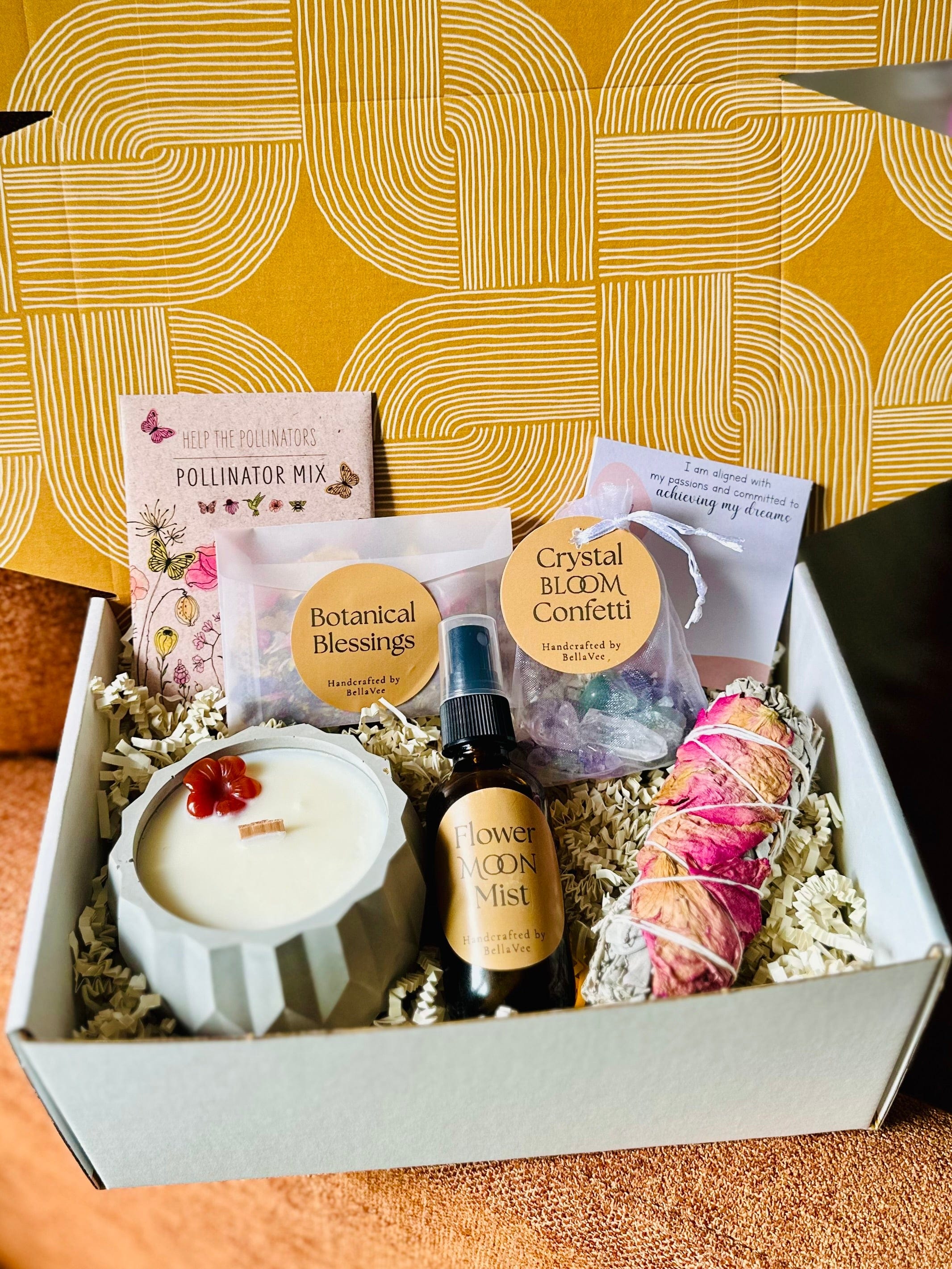 Open kraft box filled with ritual tools and dried florals