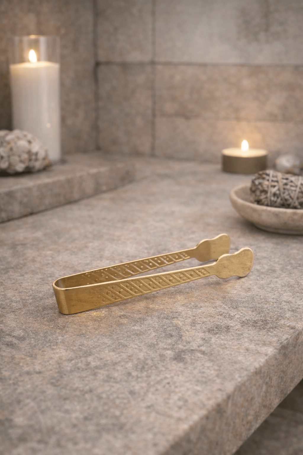 Brass charcoal tongs for handling incense charcoal discs.