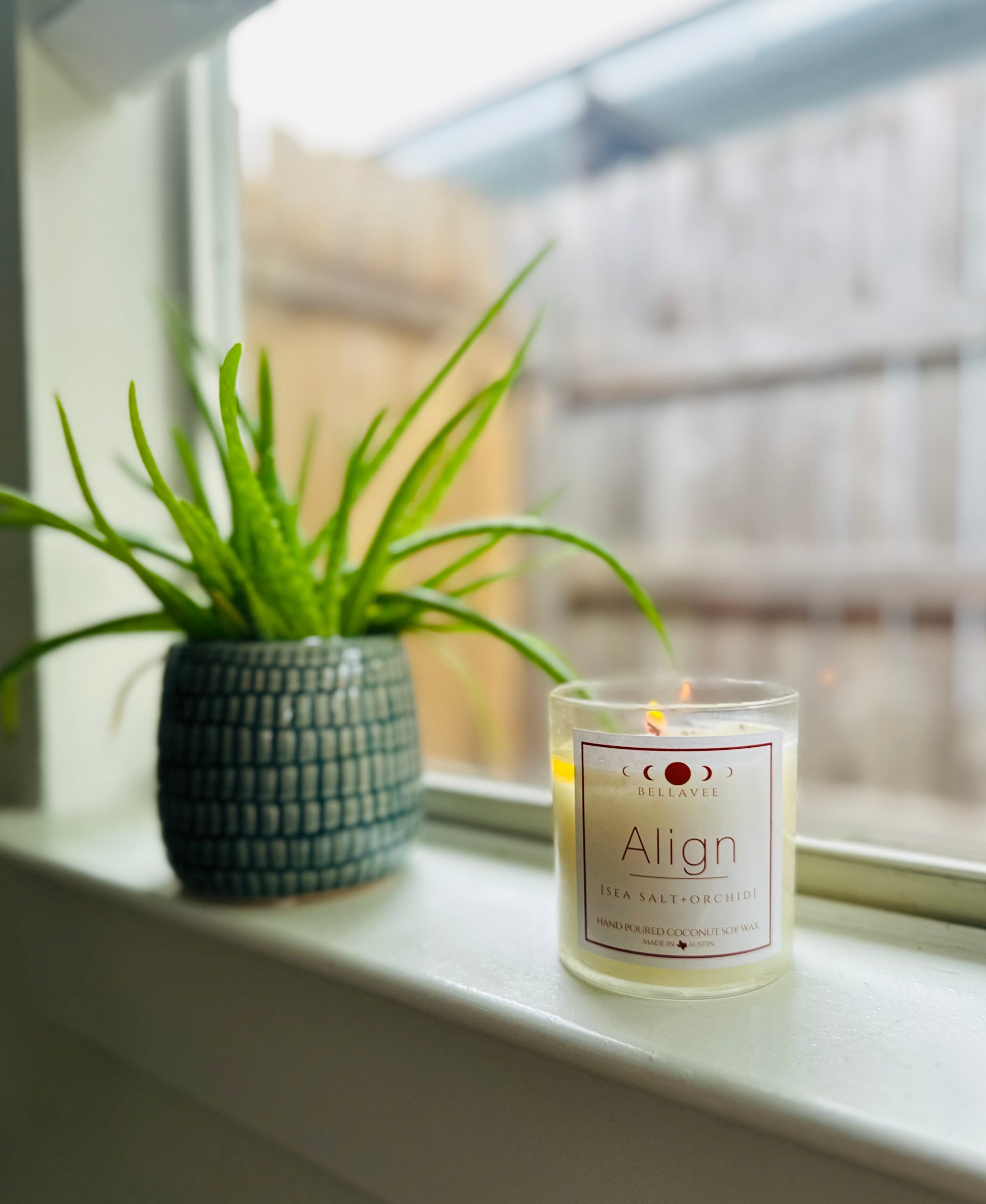 clear quartz crystal candle with wooden wick and soothing sea salt, amber, and light musk scents Align clear quartz crystal candle - infused with crystals for mindfulness and relaxation, made with eco-friendly coconut wax