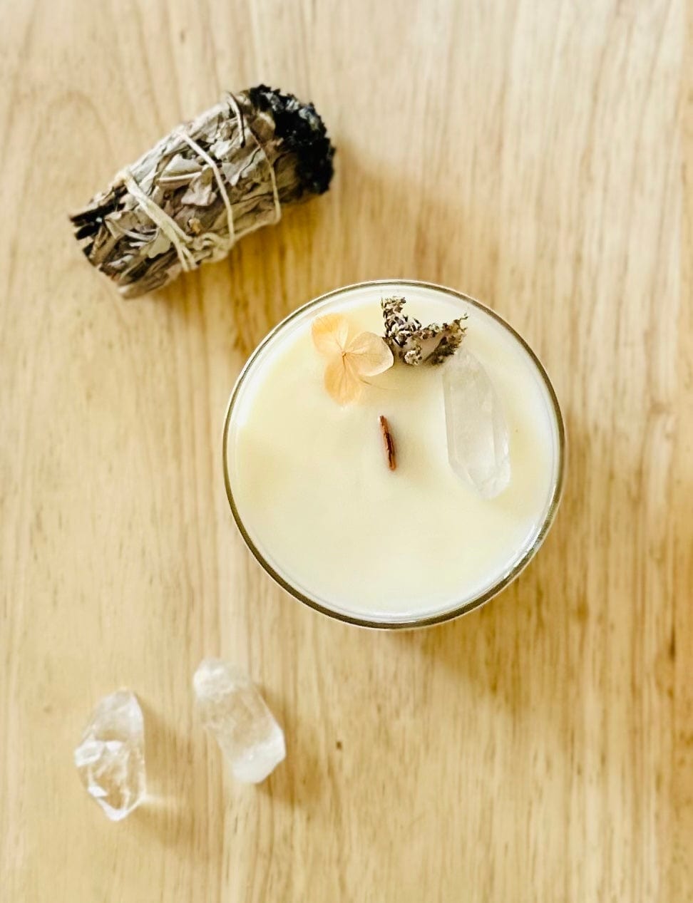 top view of align crystal candle with sage and crystals surrounding it
