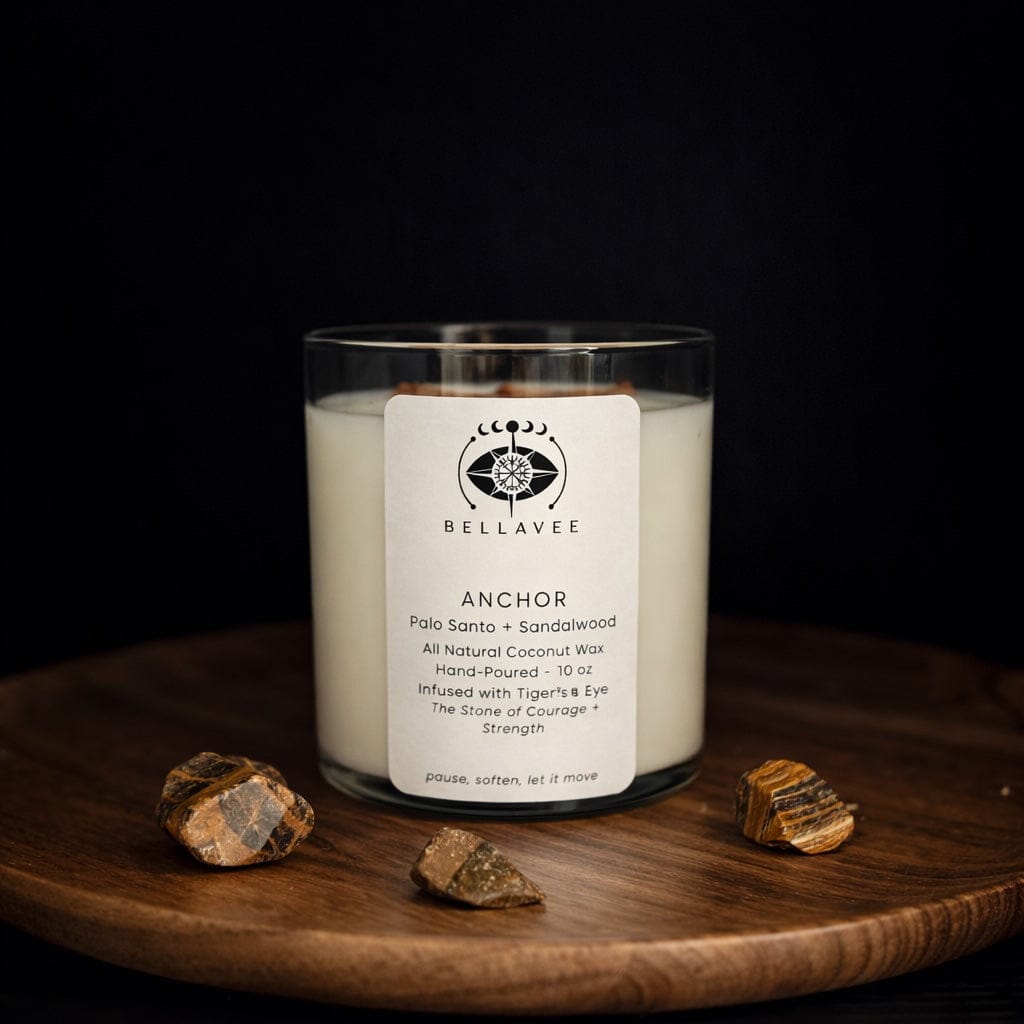 Anchor grounding ritual candle infused with tiger’s eye crystal, hand-poured coconut wax candle displayed on wood with dark, earthy tones.