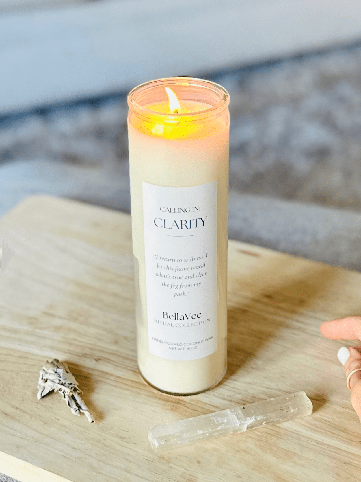 Lit Clarity Ritual Candle by BellaVee radiating soft, calming light in a serene home environment