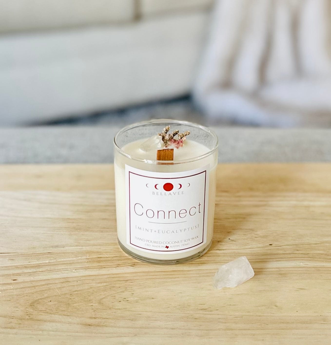 Connect CBD Crystal Candle in a reusable glass jar, styled with eucalyptus leaves and crystals, highlighting its clean aesthetic and holistic wellness purpose.