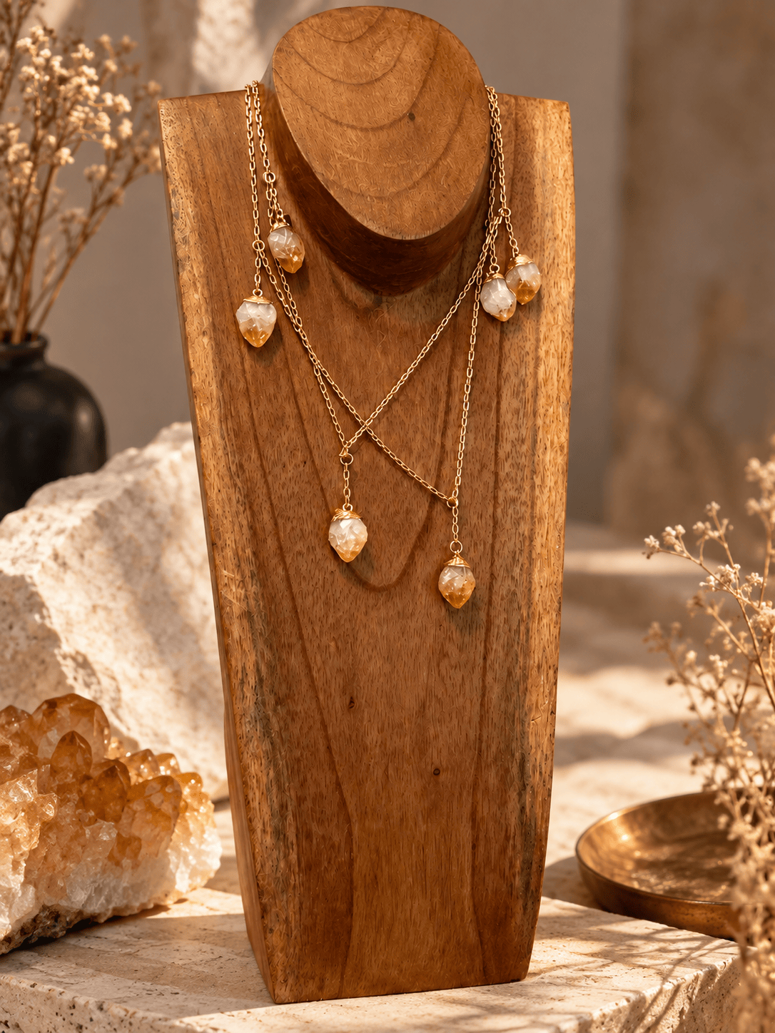 Seven-stone Citrine necklace doubled into a layered gold crystal necklace on wooden jewelry stand