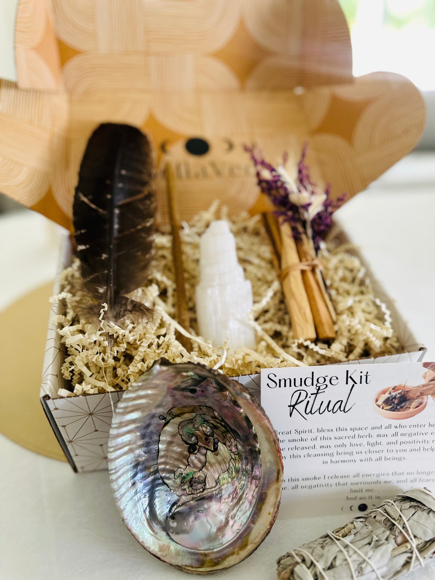BellaVee Smudge Kit offers a feather, selenite tower, abalone shell, Palo Santo incense, and a choice of sage or Palo Santo bundle