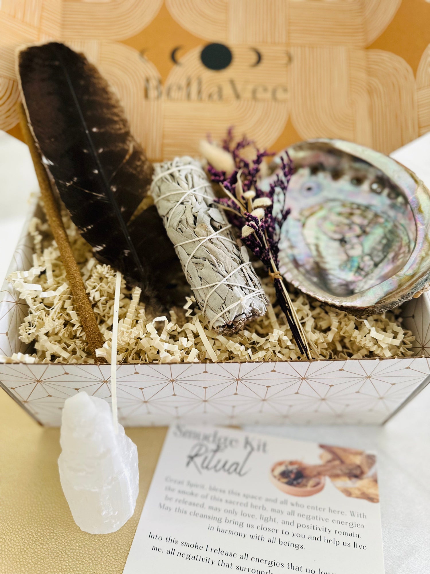 BellaVee Smudge Kit includes a feather, abalone shell, selenite tower, Palo Santo incense, and decorative flowers for a personal touch
