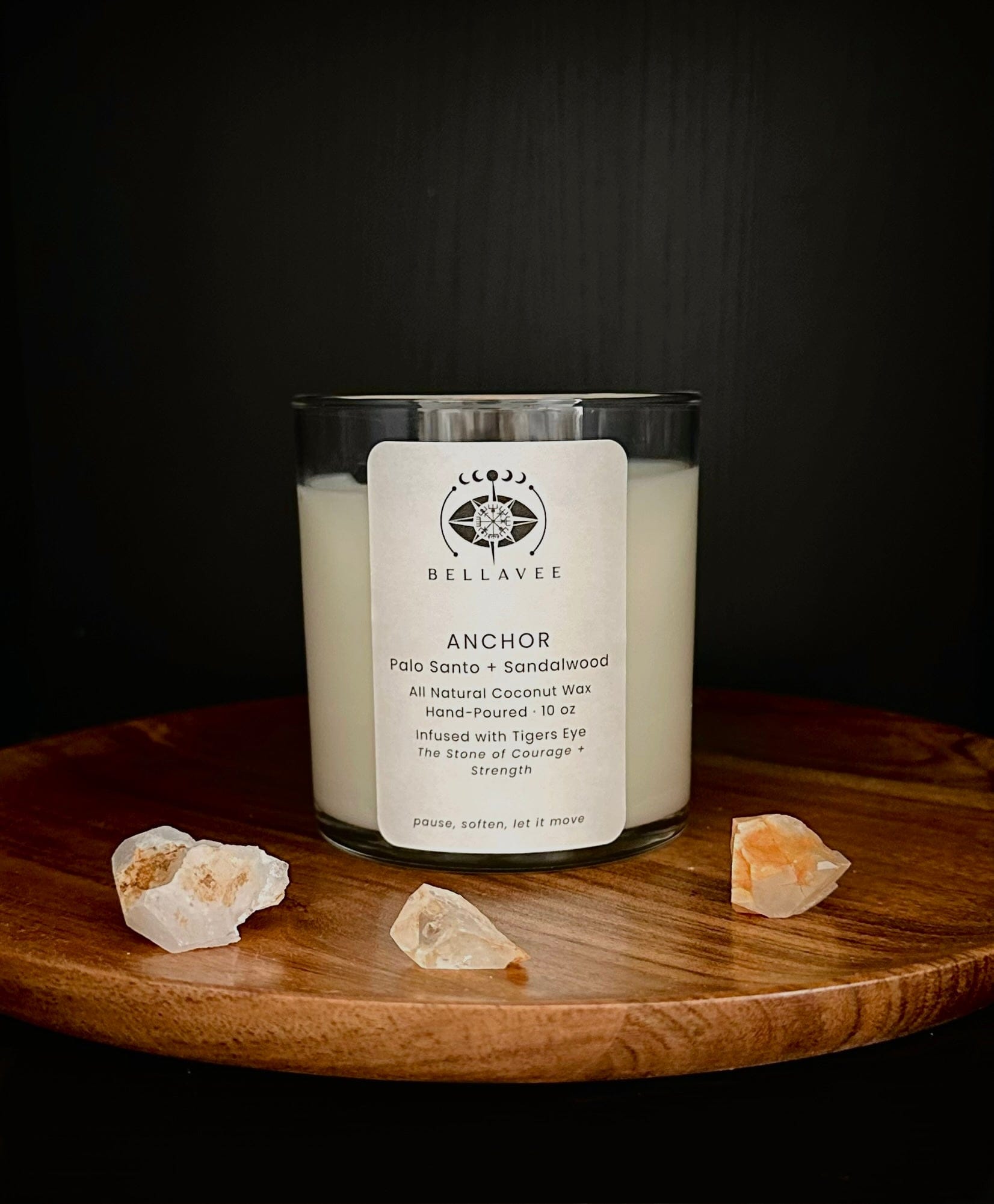 Anchor grounding ritual candle infused with tiger’s eye crystal, hand-poured coconut wax candle displayed on wood with dark, earthy tones.