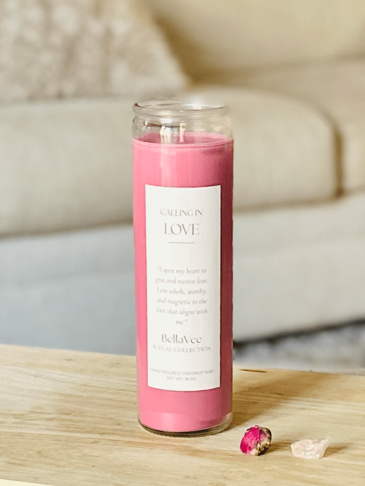 Love Ritual Candle with soft pink wax in a clear glass vessel, styled on a wooden table