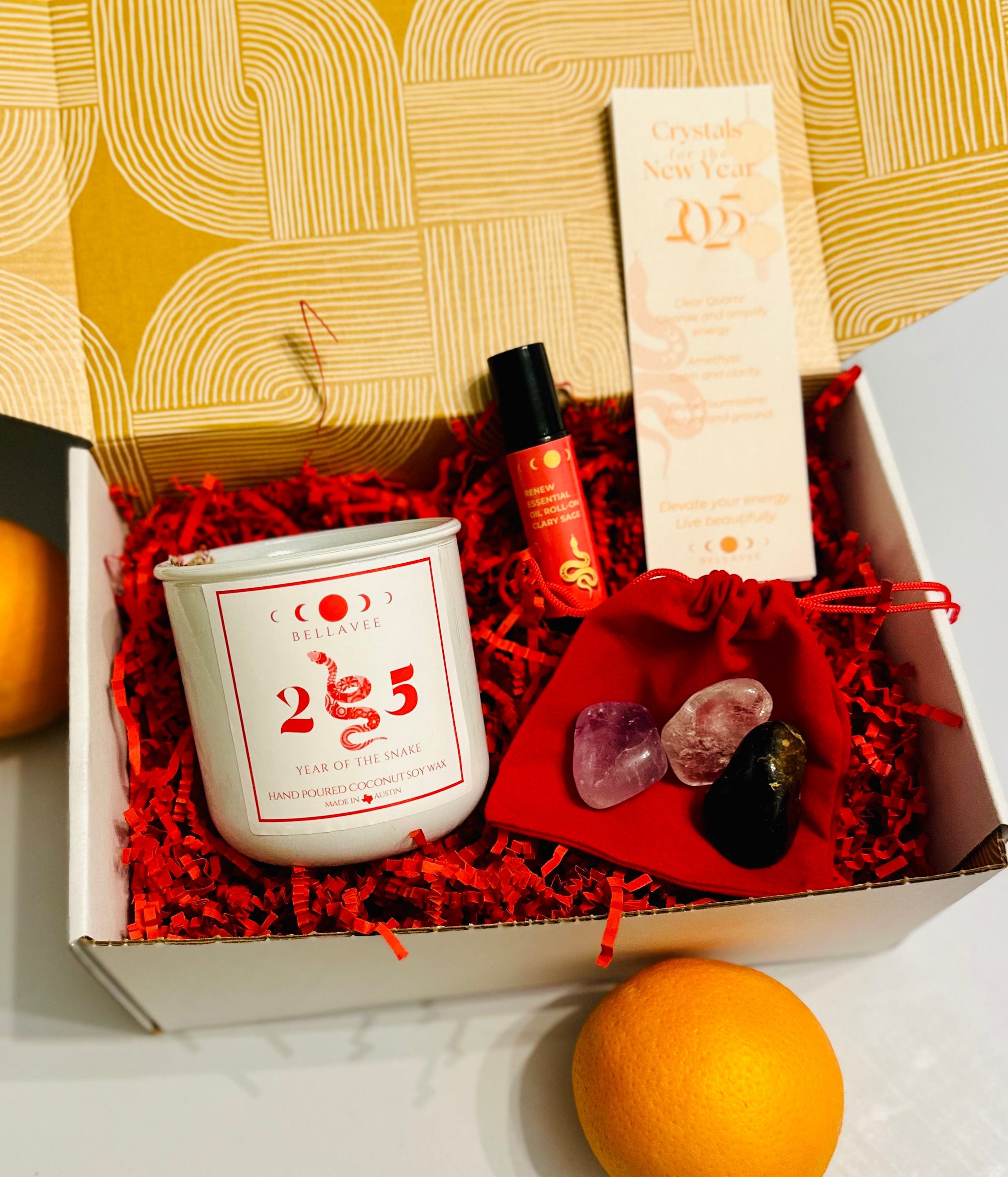 Lunar box year of the snake with bookmark and crystals for the new year. Red and gold packaging and mandarines