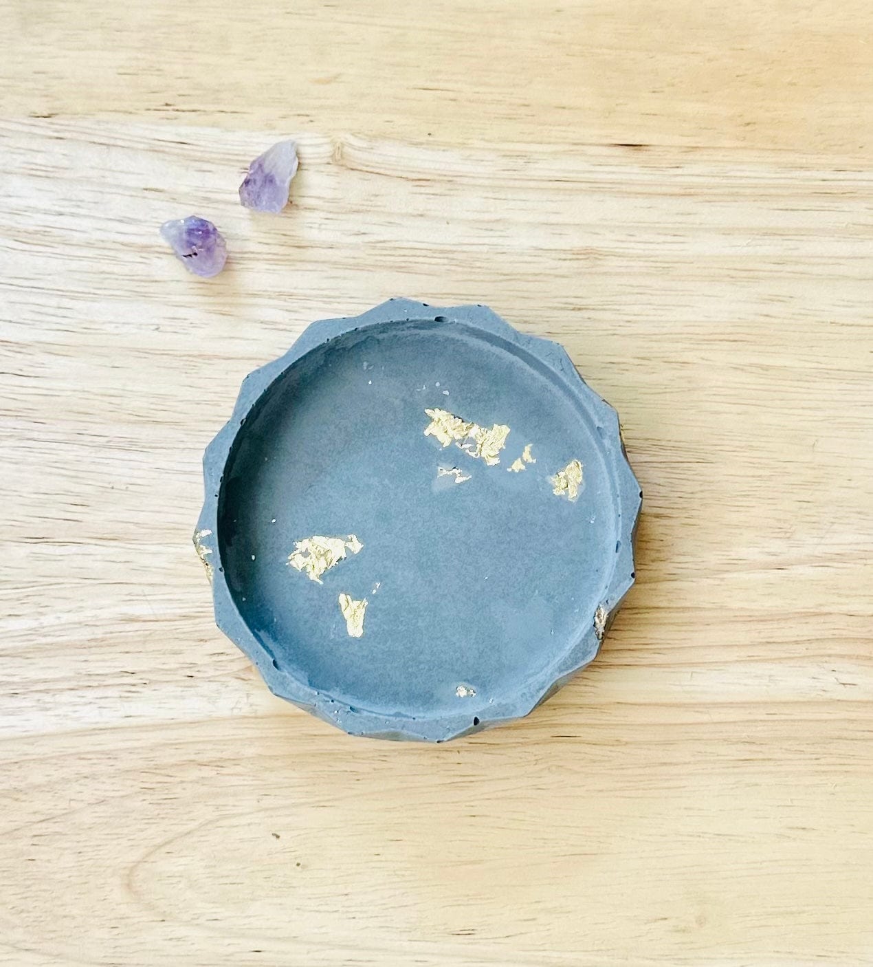 Handmade cement dish with gold flecks on neutral background