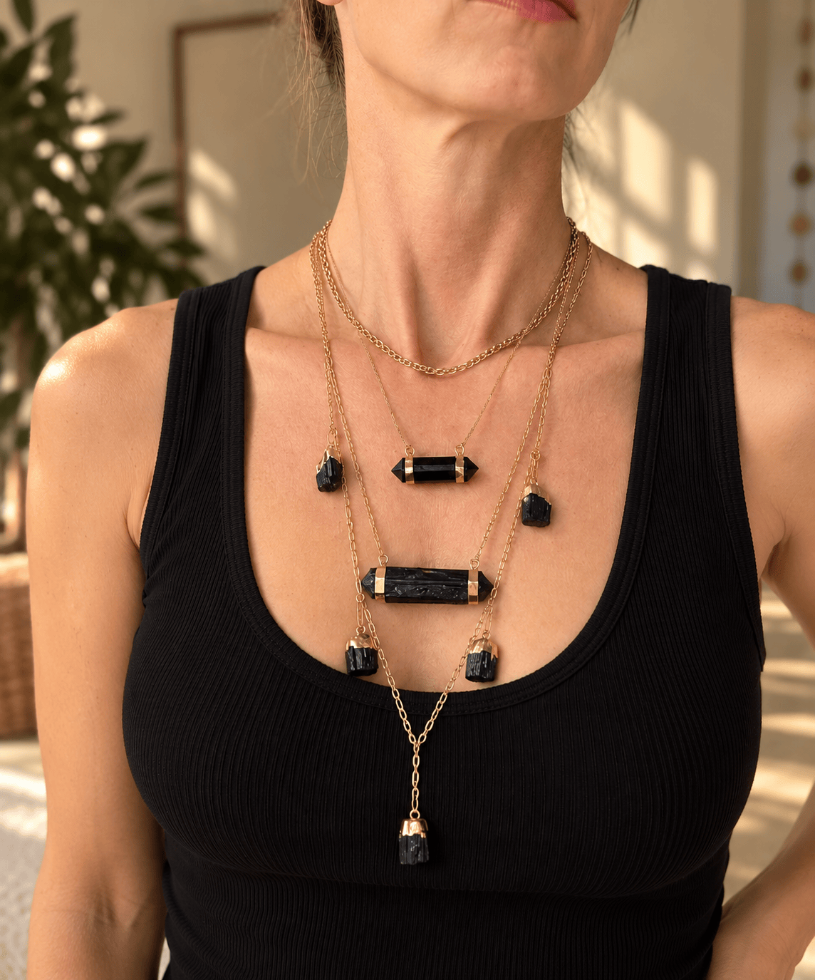 Raw Black Tourmaline bar necklace worn in a layered BellaVee crystal necklace stack
