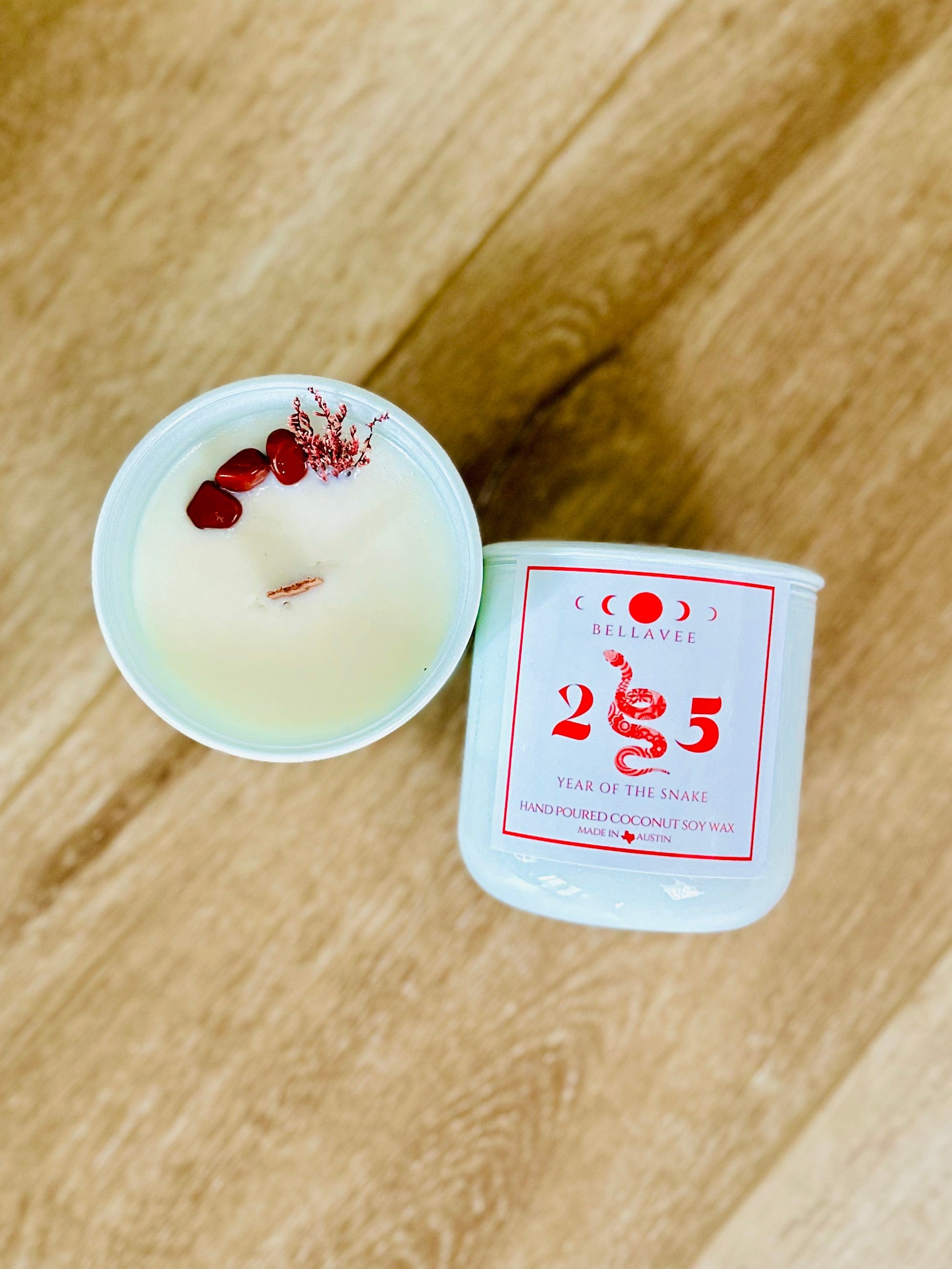 Hand-poured coconut wax Year of the Snake Candle with Red Jasper for balance and Palo Santo and Sandalwood for spiritual cleansing.