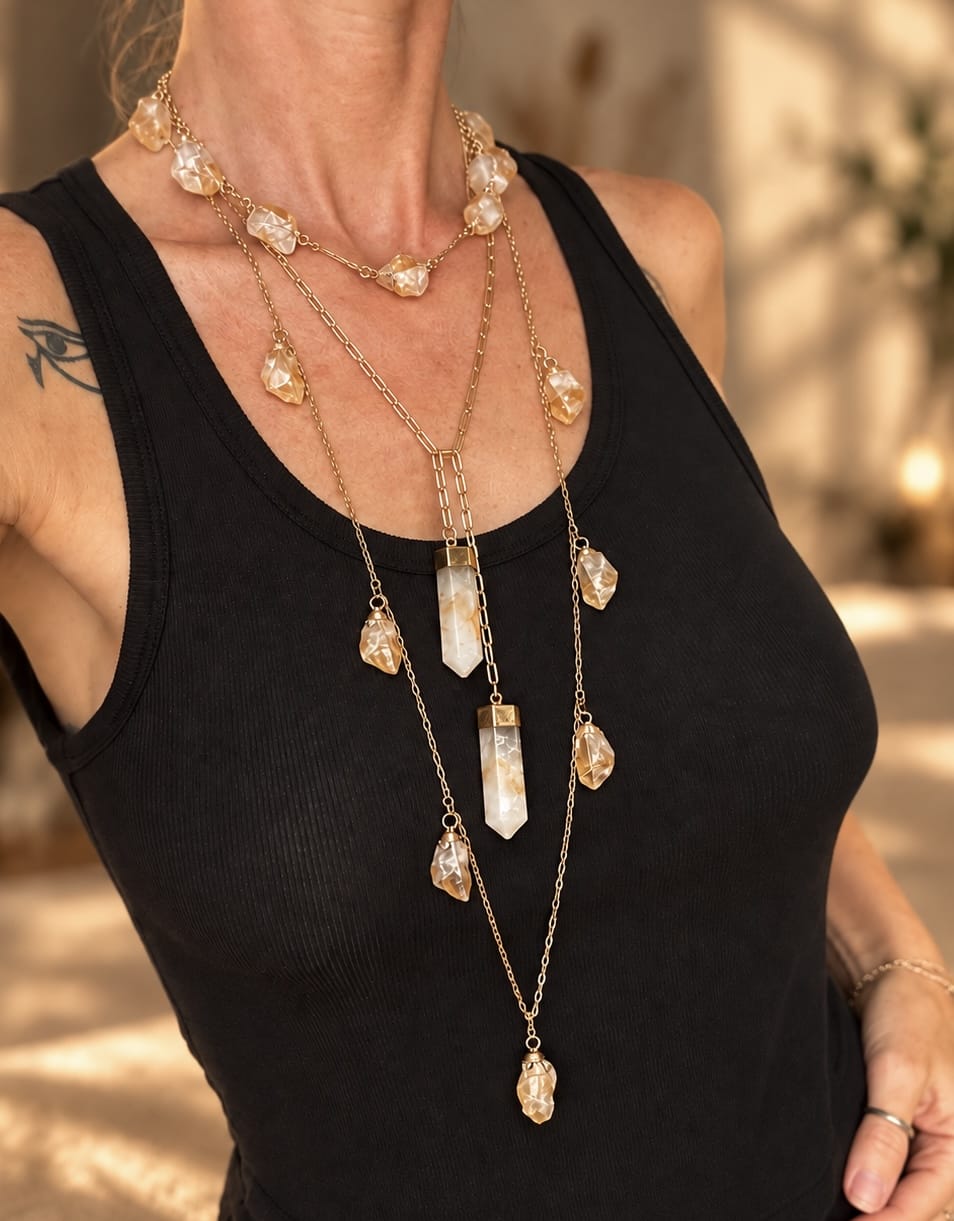 Two-stone crystal lariat necklace worn in a layered crystal necklace stack