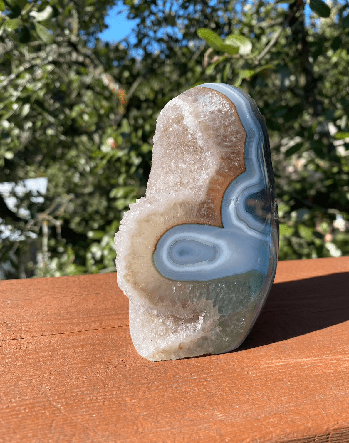 baby blue agate with quartz crystals shimmering under the sun, enhancing its natural beauty and energy-stabilizing properties
