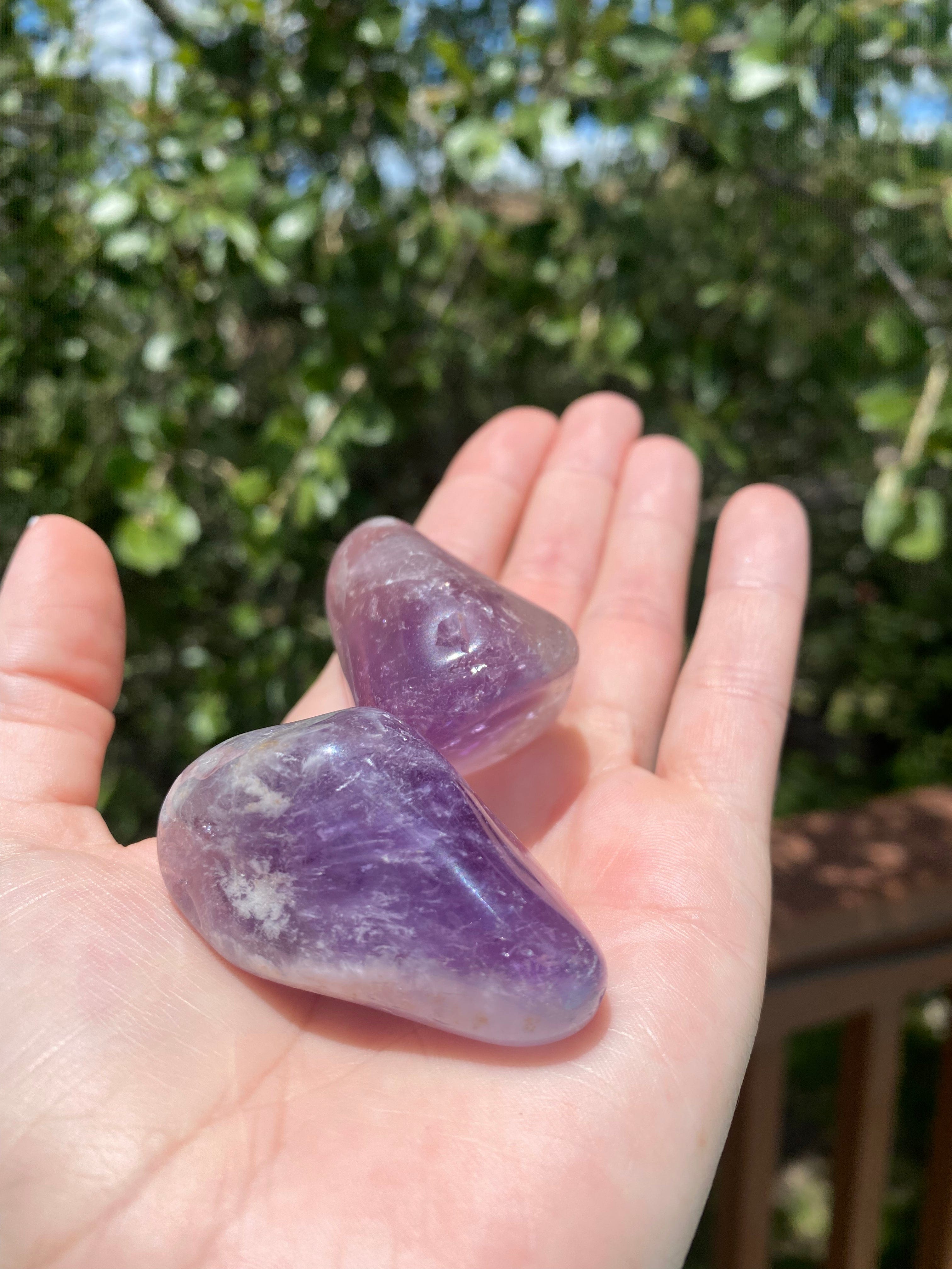 Amethyst tumble stone, offering healing and cleansing powers, enhancing spiritual awareness and psychic abilities.