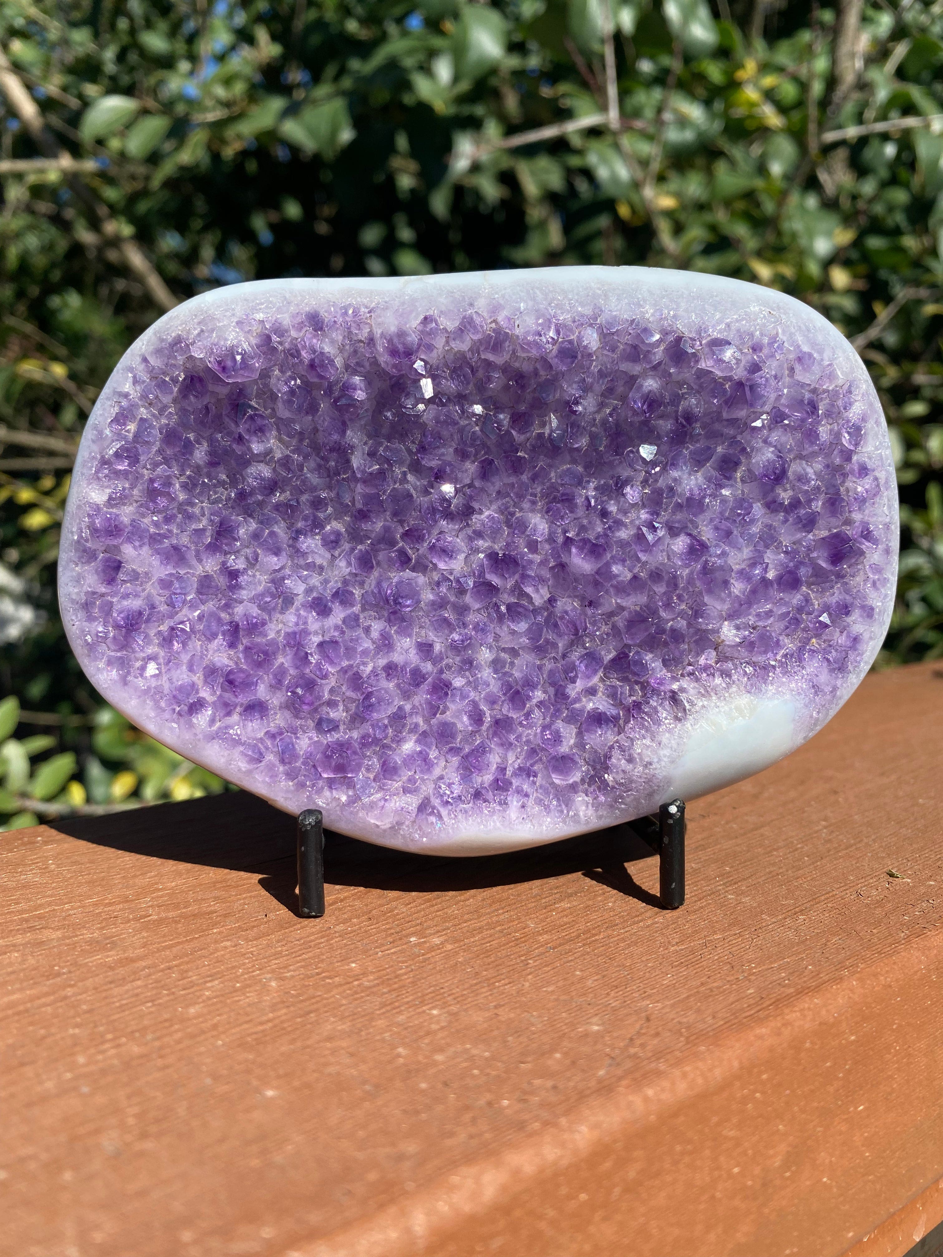 Large Amethyst crystal with vibrant purple shine and Agate banding, glowing under the sun, offering healing energy.