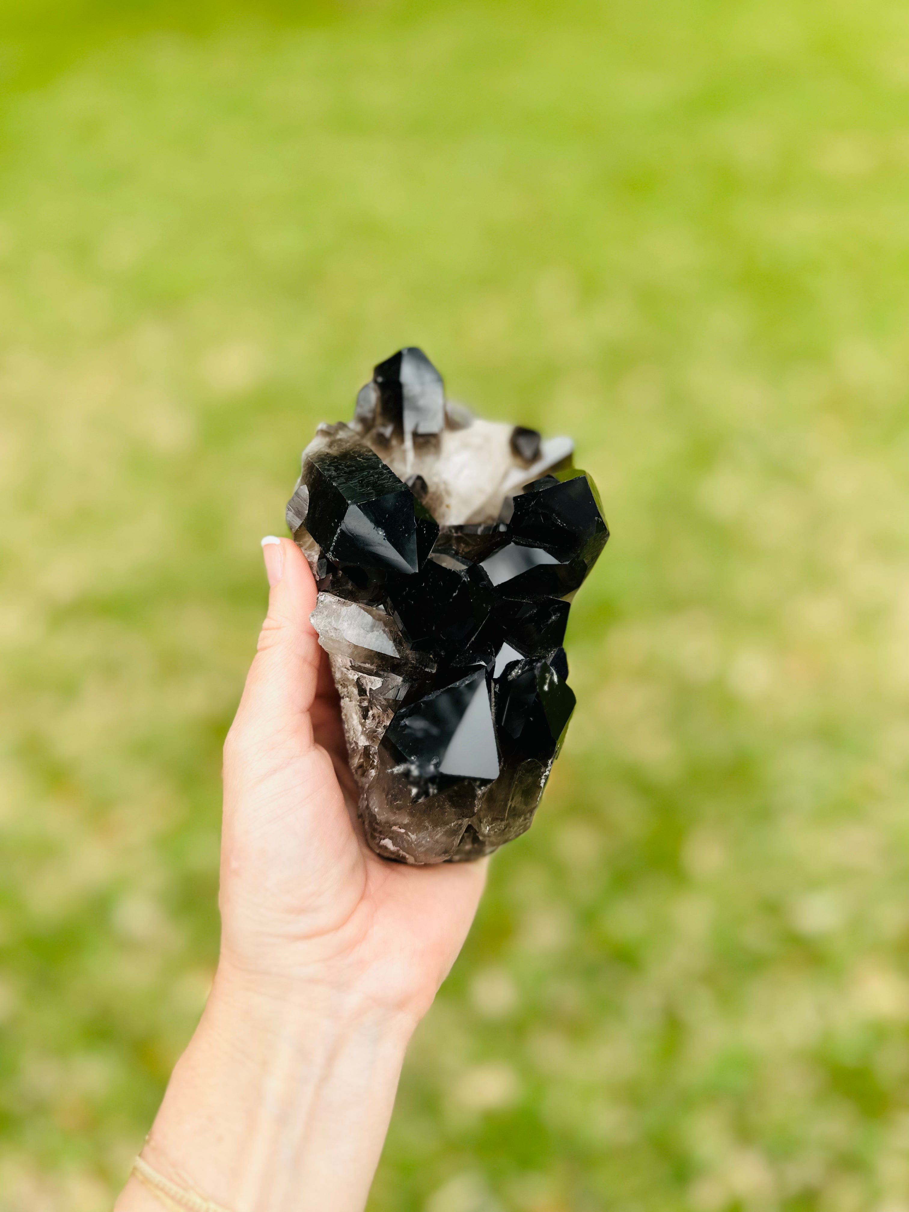 Black Quartz crystal glistening in the sunlight, providing grounding and protection from negative energies