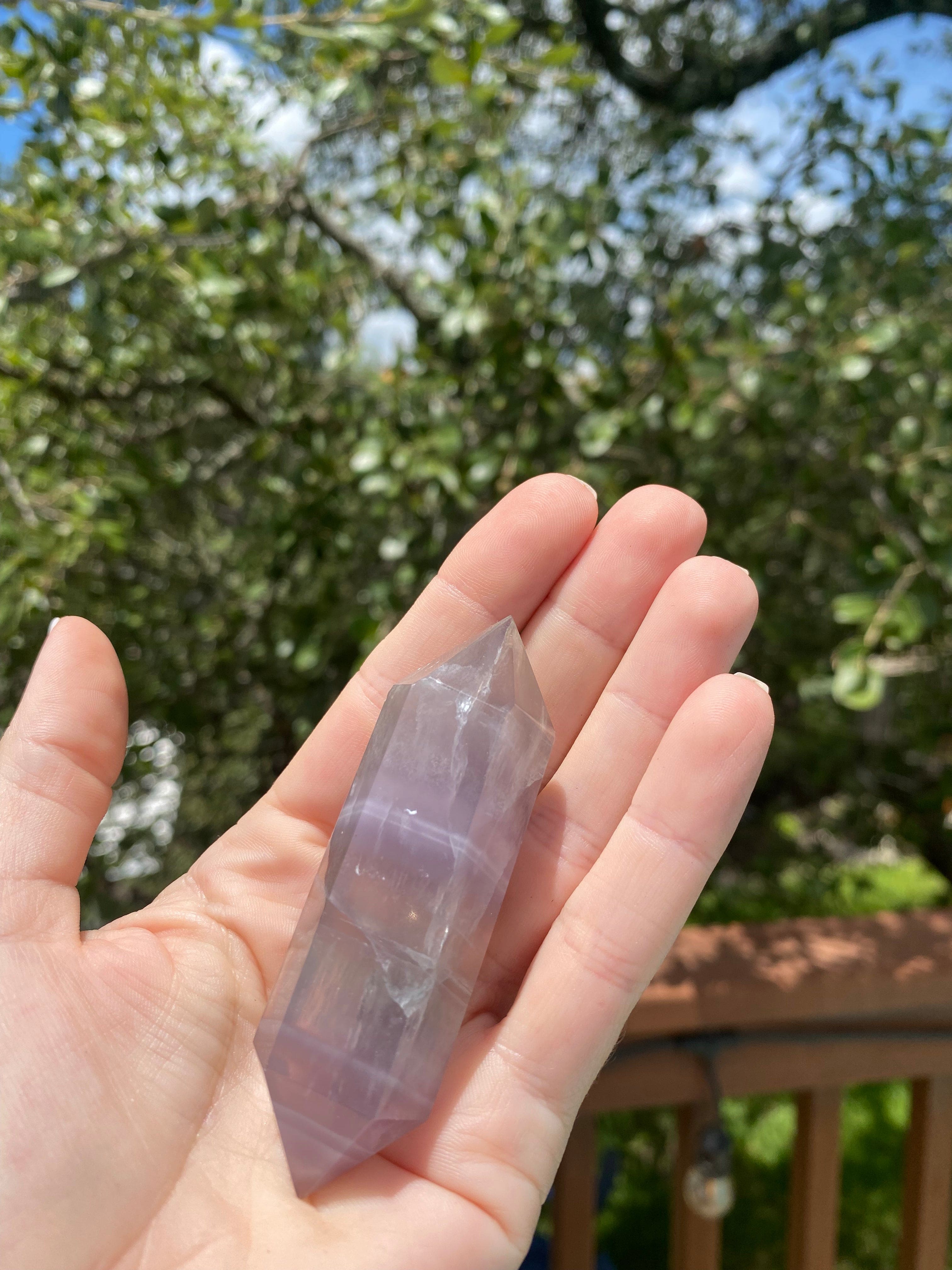 double-terminated fluorite crystal, absorbs negative energy, detoxifies the mind, and promotes clarity and peace with a calming energy