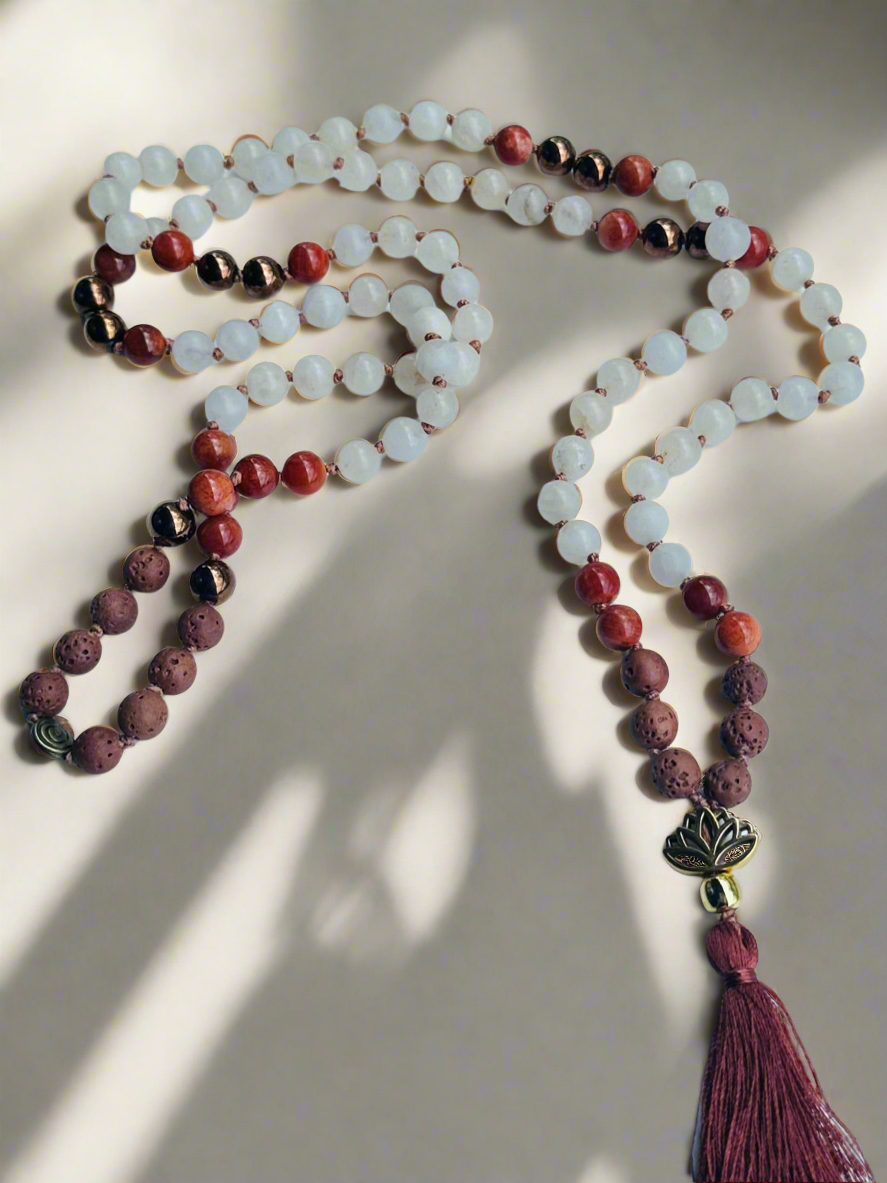 elemental balance mala crafted with white jade for peace, red jasper for grounding, gold hematite for strength, and lava for courage