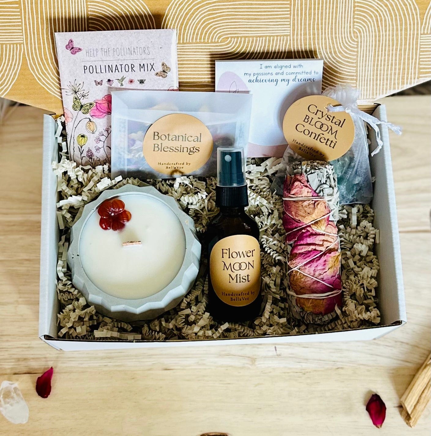 Flat lay of Full Moon Ritual Box with mist, candle, flowers, and crystals