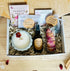 Flat lay of Full Moon Ritual Box with mist, candle, flowers, and crystals