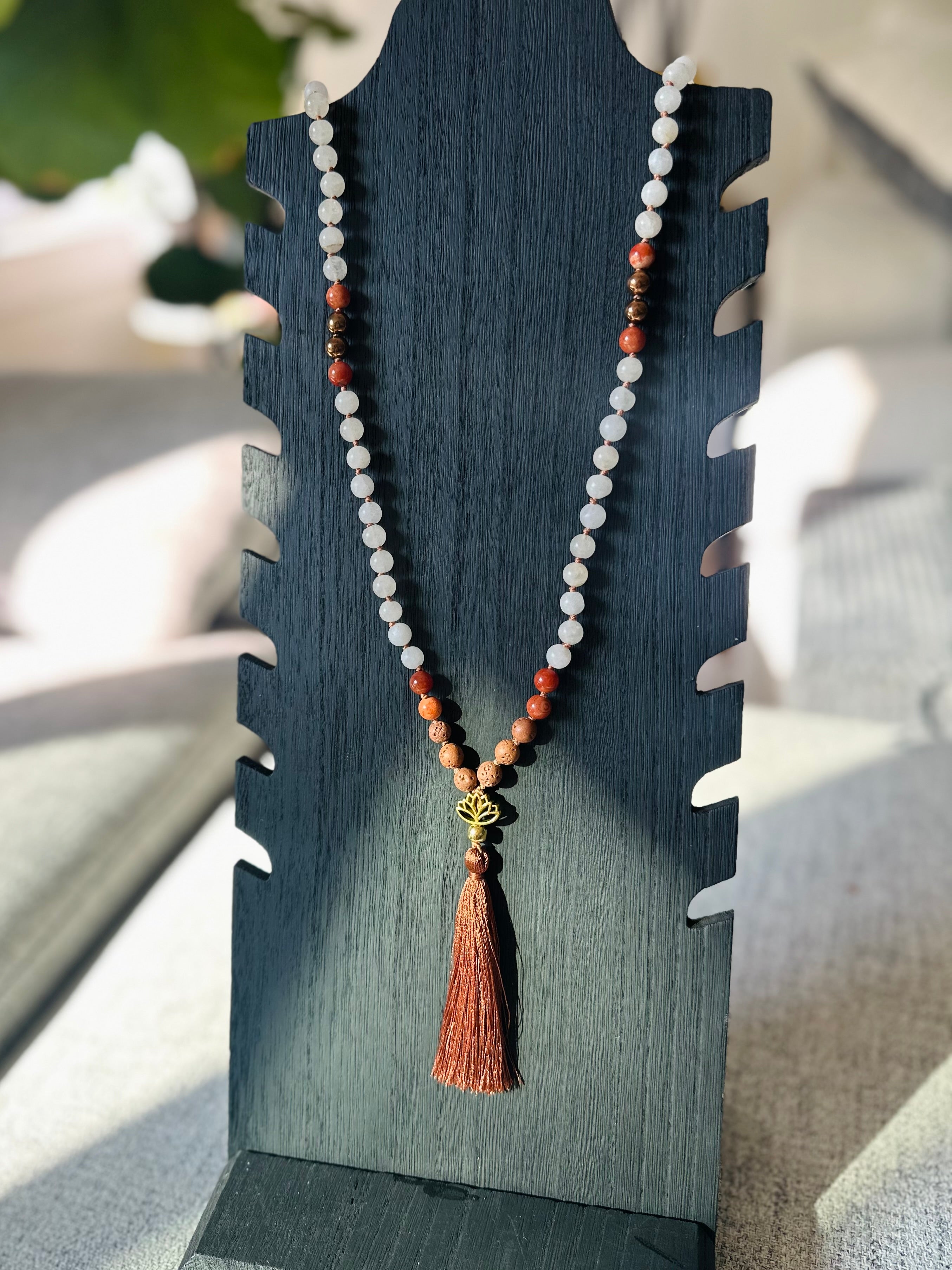 elemental balance crystal mala with white jade, red jasper, gold hematite, and lava stones, symbolizing grounding, protection, and vitality