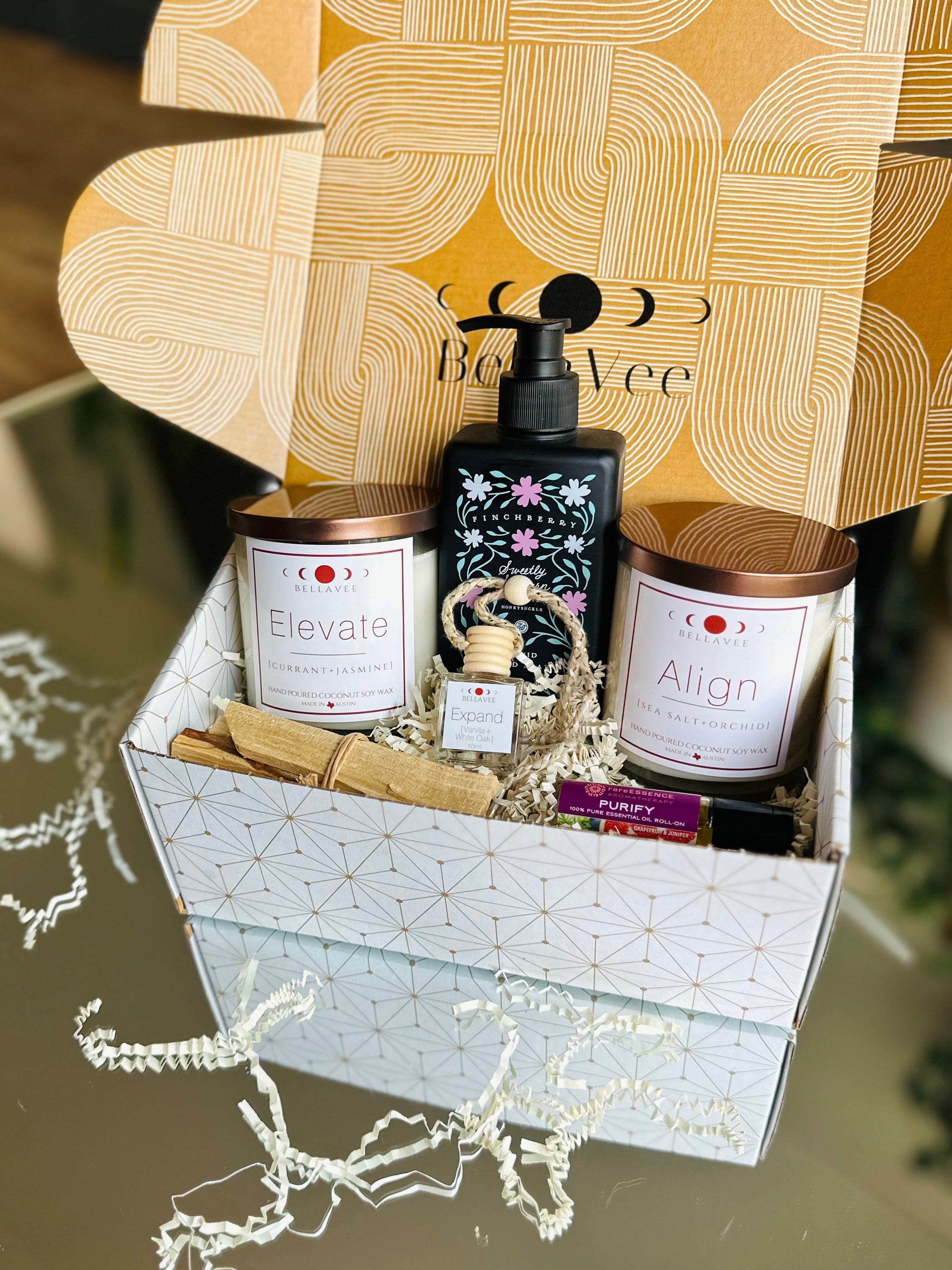 Luxurious New Home Firsts Gift Box with crystal candles, essential oils, hand soap, and Palo Santo, creating a peaceful, welcoming atmosphere