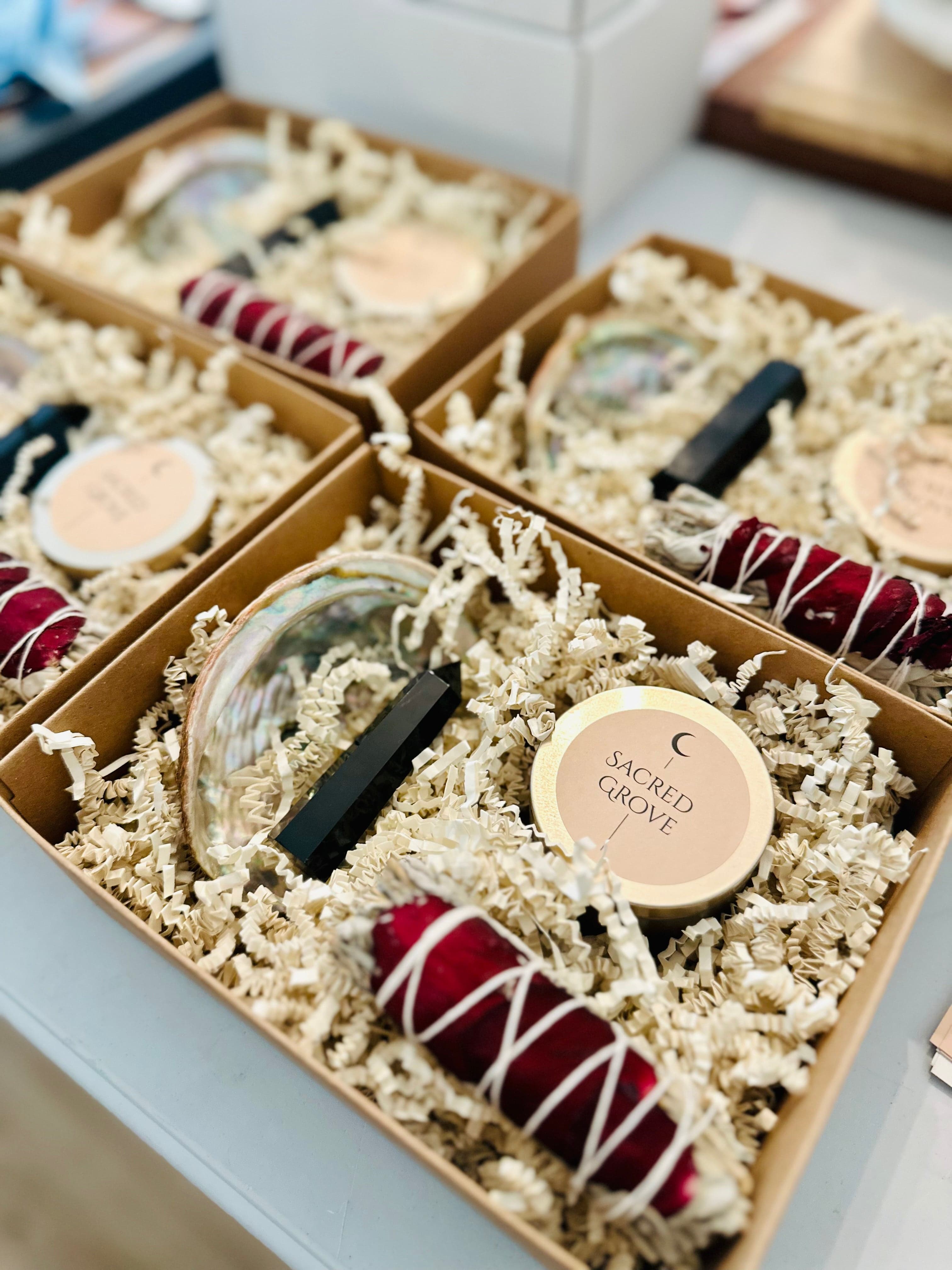 Top view of hand-packed ritual kits ready for gifting, featuring small self-care items in earthy packaging.