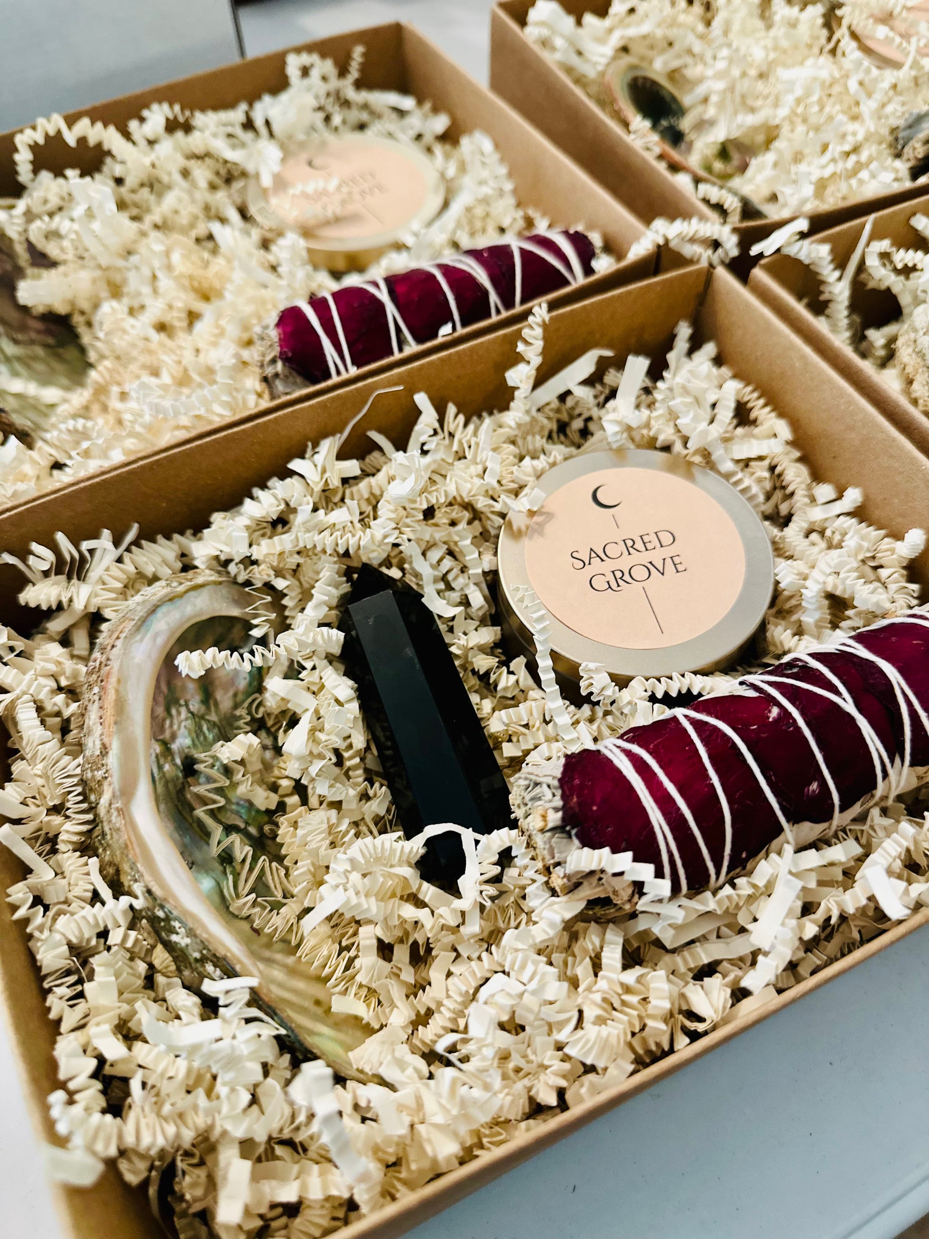  A minimalist ritual kit featuring a mini candle, sage bundle, and abalone shell in natural packaging.