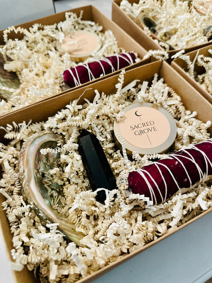  A minimalist ritual kit featuring a mini candle, sage bundle, and abalone shell in natural packaging.
