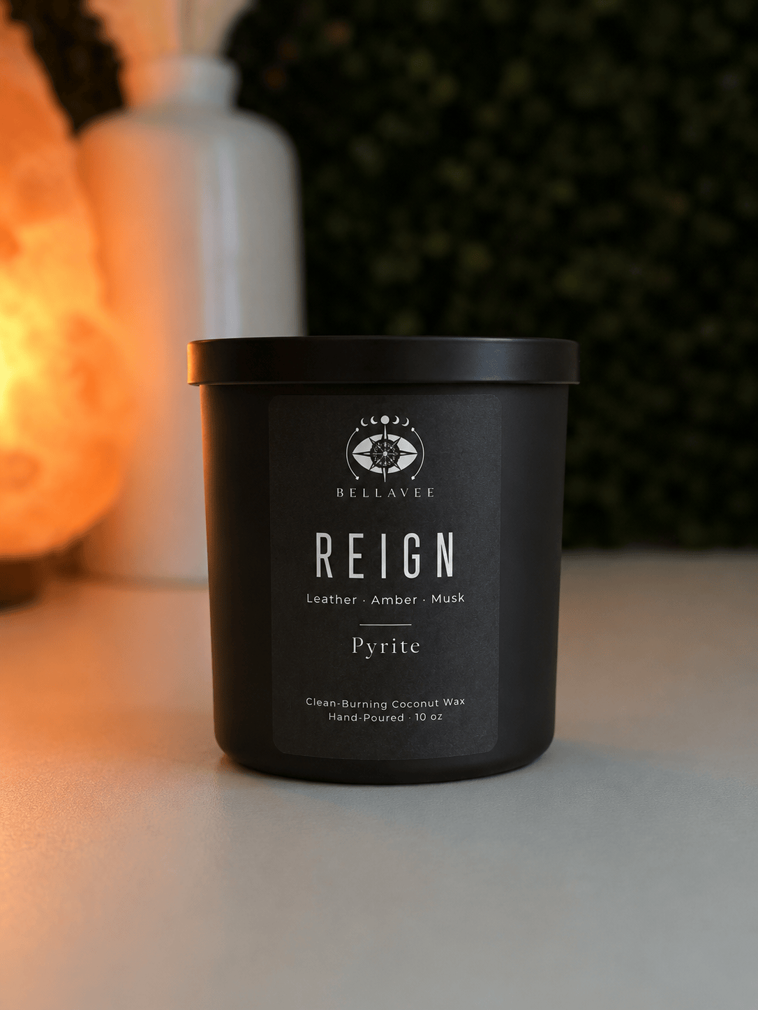 Reign leather amber musk Pyrite crystal candle by BellaVee in matte black vessel