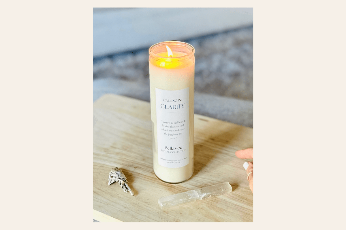 Tall Calling in Clarity Candle with a label on a wooden surface