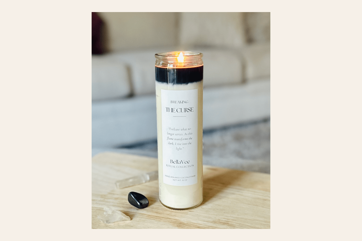 tall Candle with a label on a wooden surface 