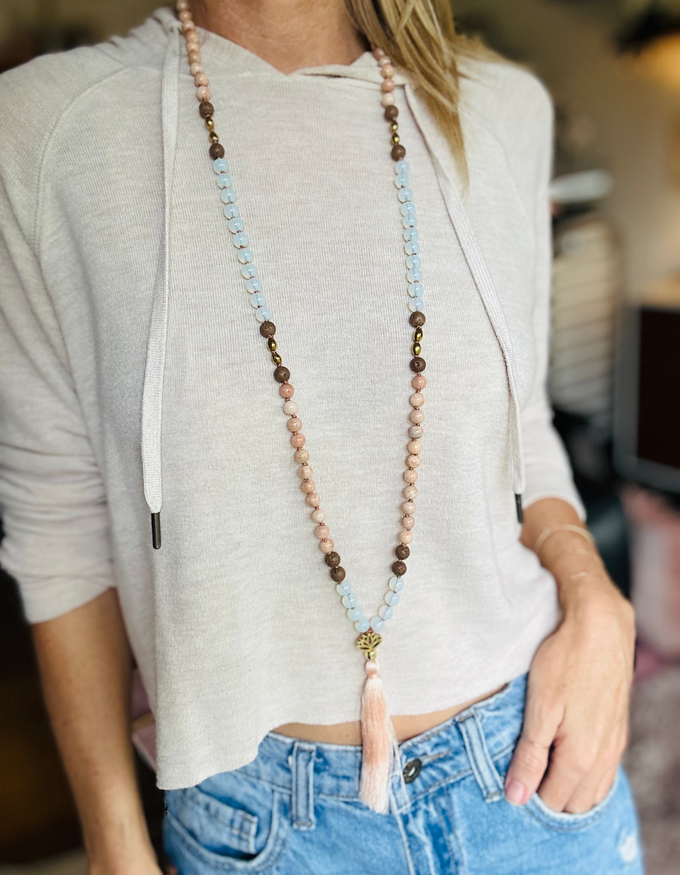 Wearing the Goddess Powerhouse Mala offers grounding from Lava and emotional balance from Peach Moonstone, fostering inner strength