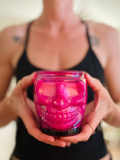 Pink skull candle in hands ready for the ritual