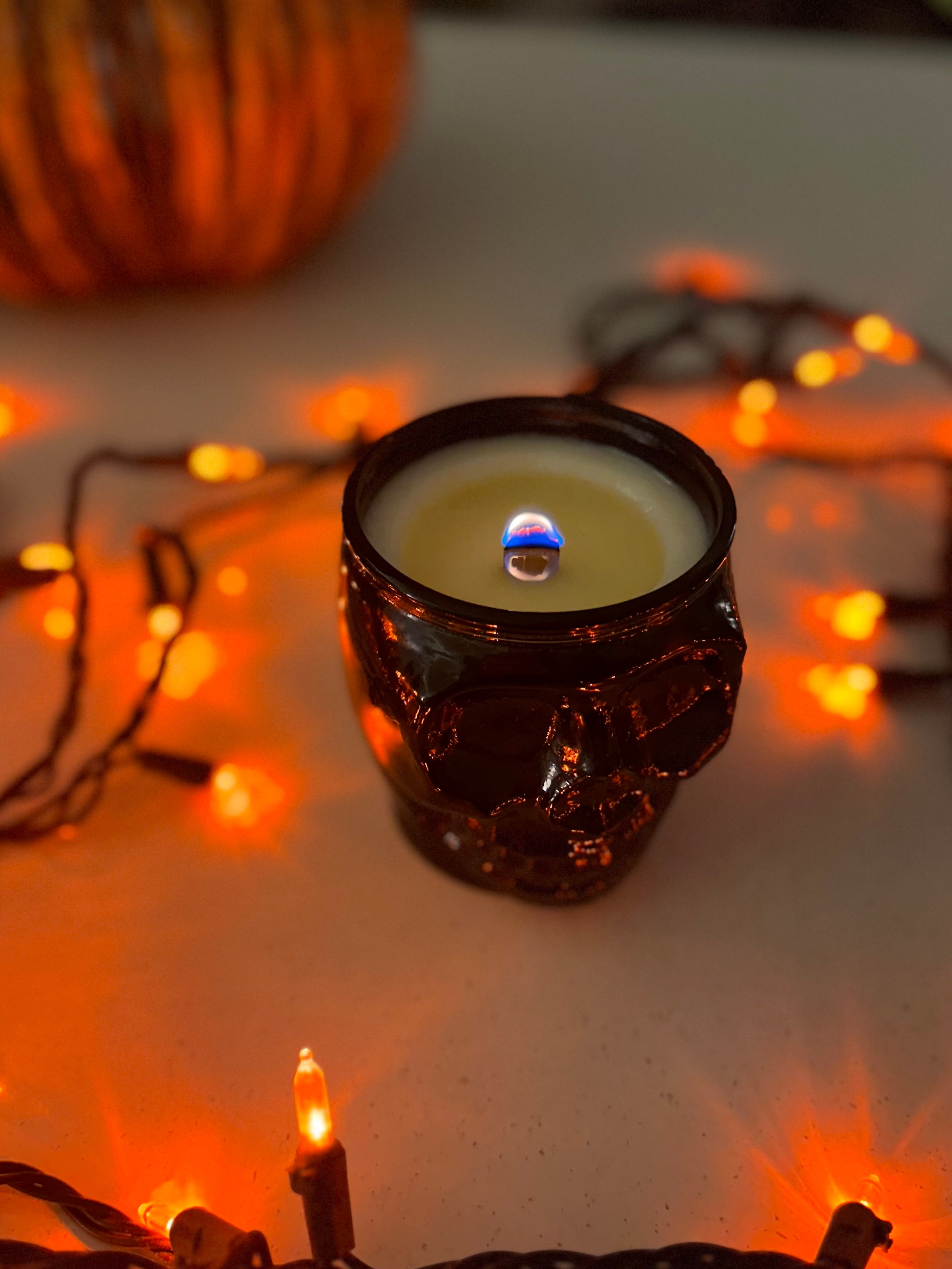 Grim Skull Candle, 13.5 oz, with cinnamon and vanilla scents, in a keepsake recycled glass vessel, perfect for autumn and Halloween décor