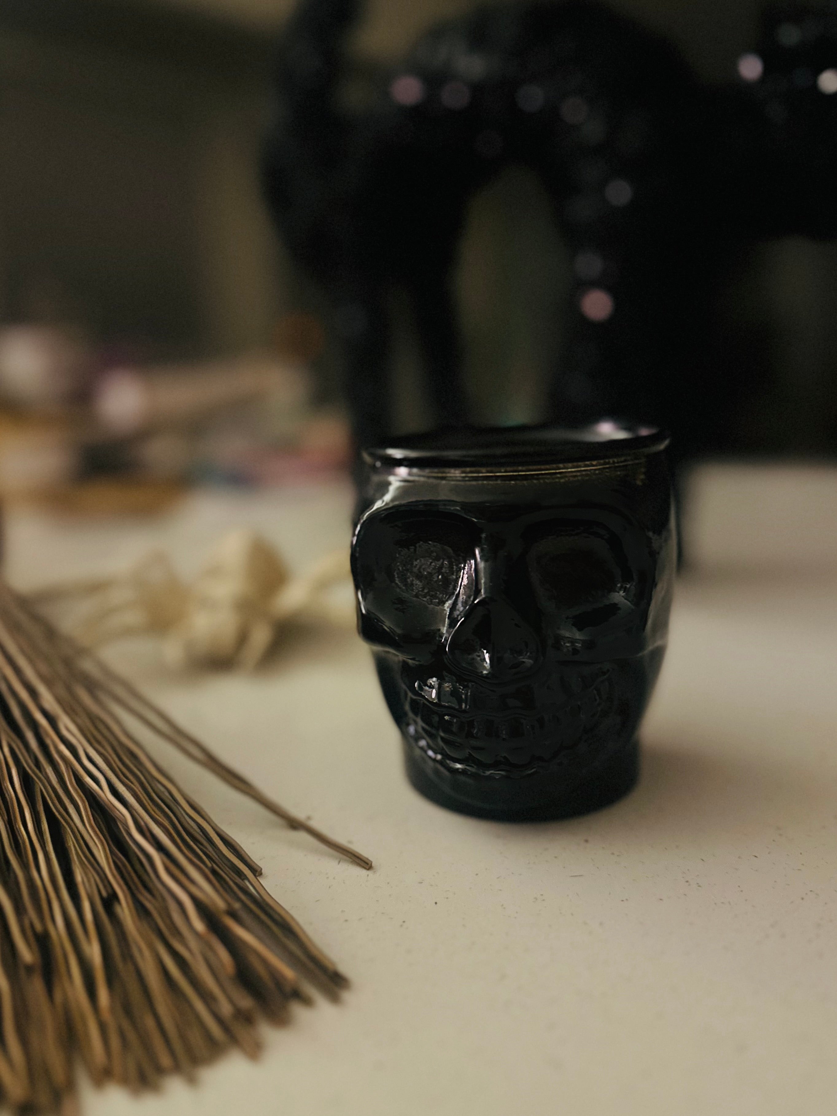 Halloween Grim Skull Candle, 13.5 oz, hand-poured in recycled glass with warm cinnamon and vanilla scents, ideal for seasonal décor