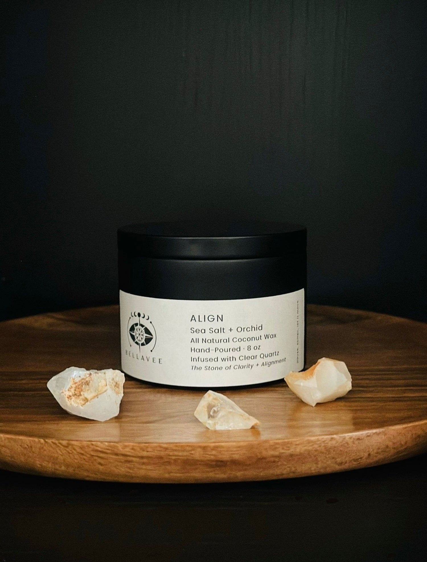 Align Clear Quartz crystal candle tin for clarity and energetic alignment on wooden tray with crystals and dark background.