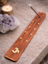 Om wooden incense holder with brass stars for meditation and incense burning.