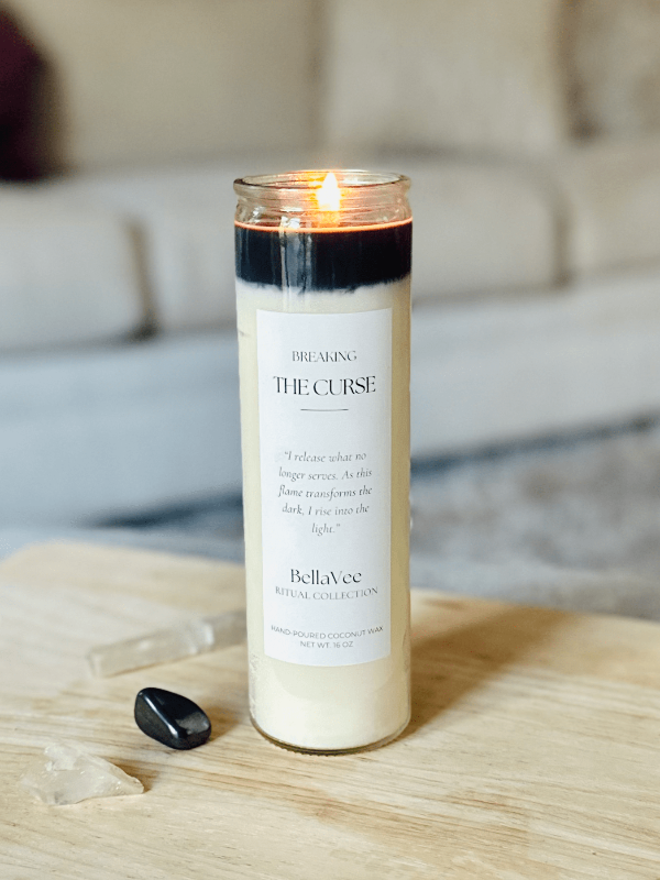 Breaking The Curse candle lit, symbolizing transformation and energetic release.