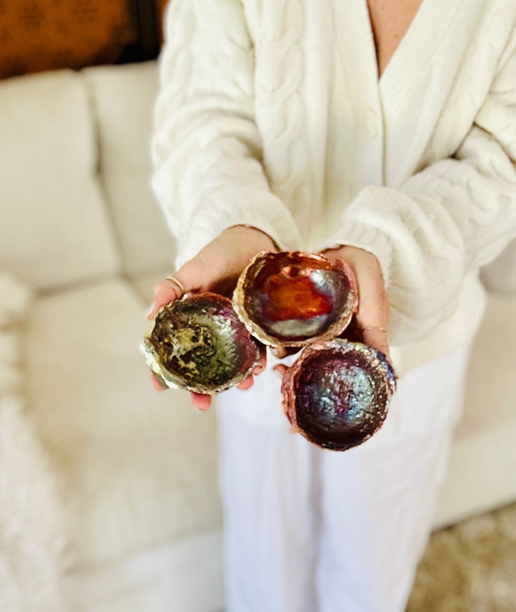Multiple Copper bowls held hands to show size, color and shape