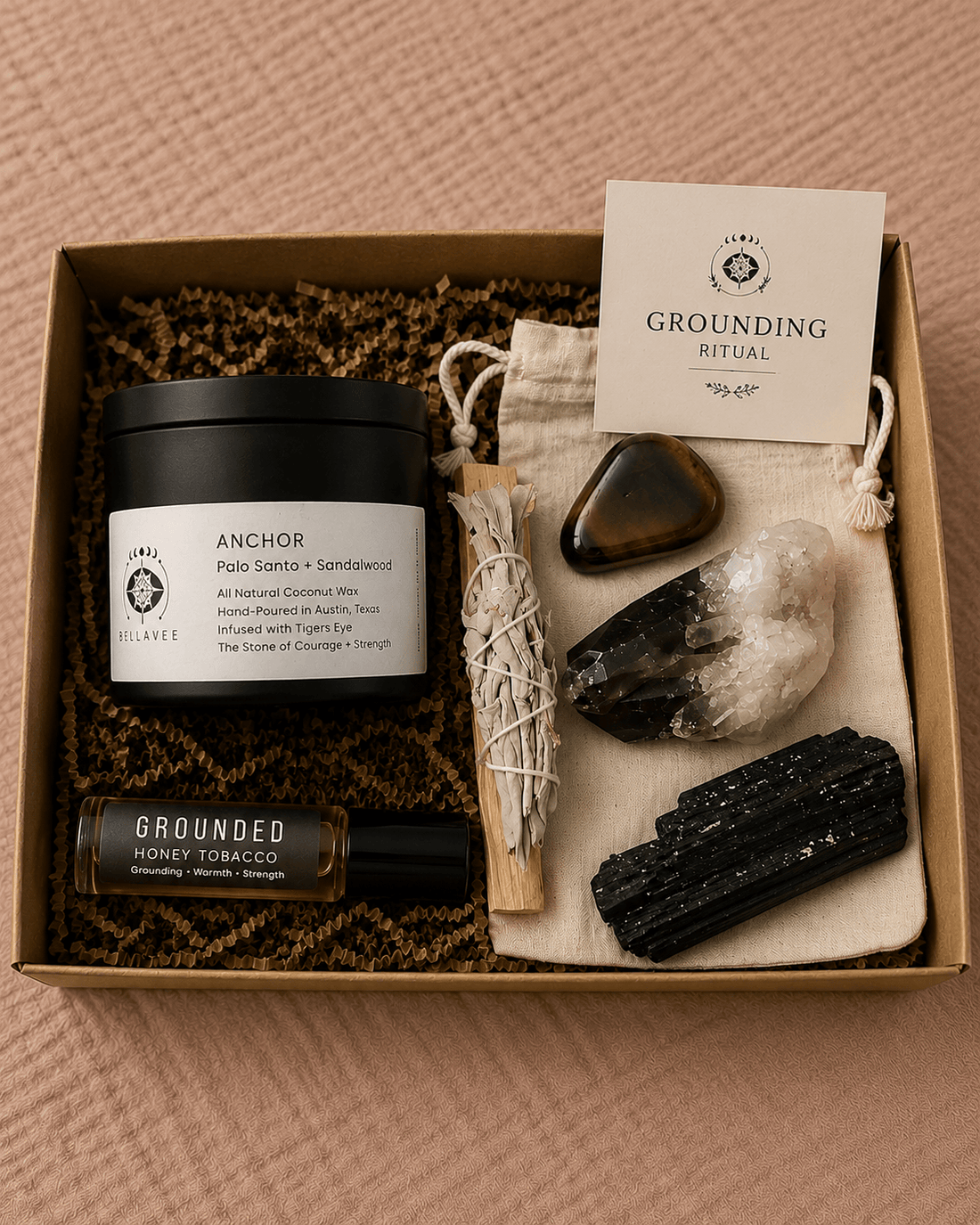 Grounding Ritual Kit with Anchor candle, grounding crystals, sage, palo santo, perfume oil, and cotton pouch in a kraft gift box.