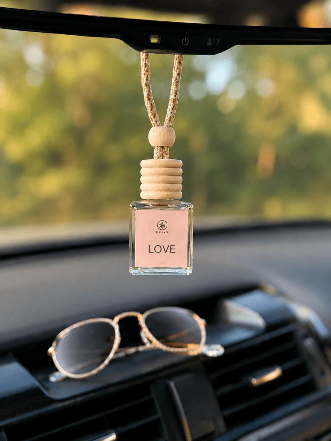 Sugar and Berry non-toxic car diffuser by BellaVee, hanging from rearview mirror