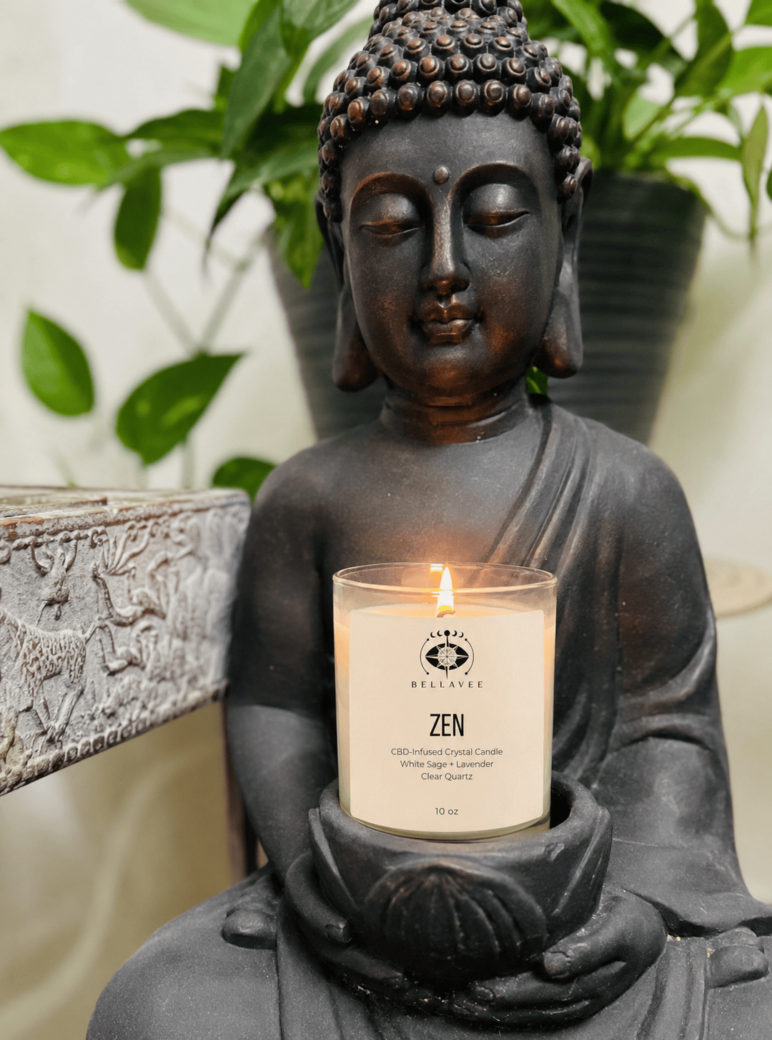BellaVee ZEN CBD-infused crystal candle featuring white sage and lavender fragrance, clear quartz crystal, and a wooden wick, styled in a calming meditation space with a Buddha candle holder.