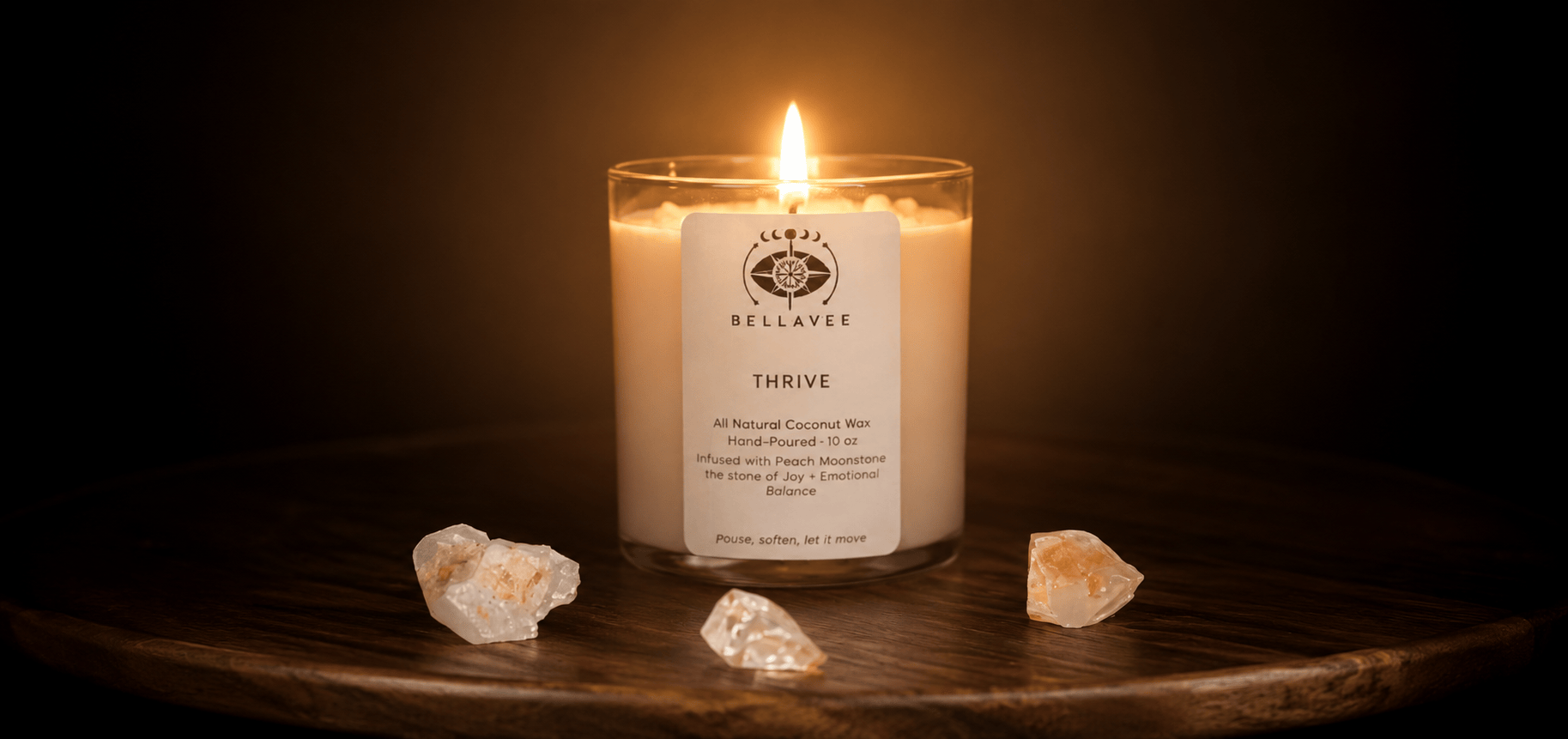 BellaVee THRIVE crystal candle with peach moonstone crystal, wooden wick, and all-natural coconut wax, glowing in a warm, intentional living space."