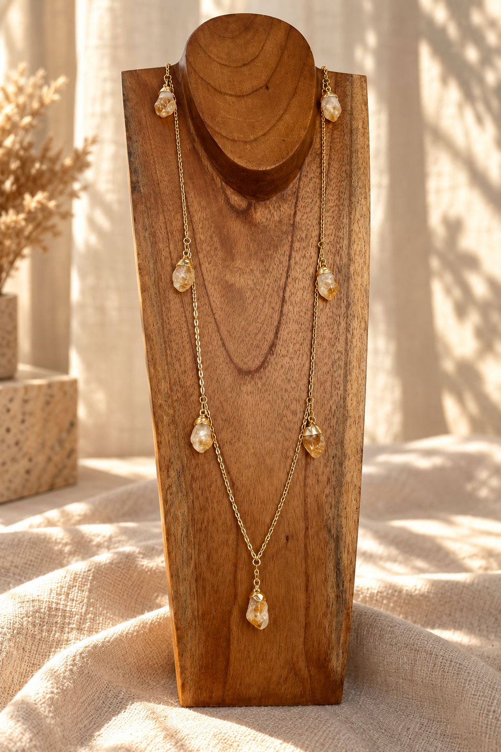 Seven-stone Citrine convertible necklace worn long on a wooden jewelry stand