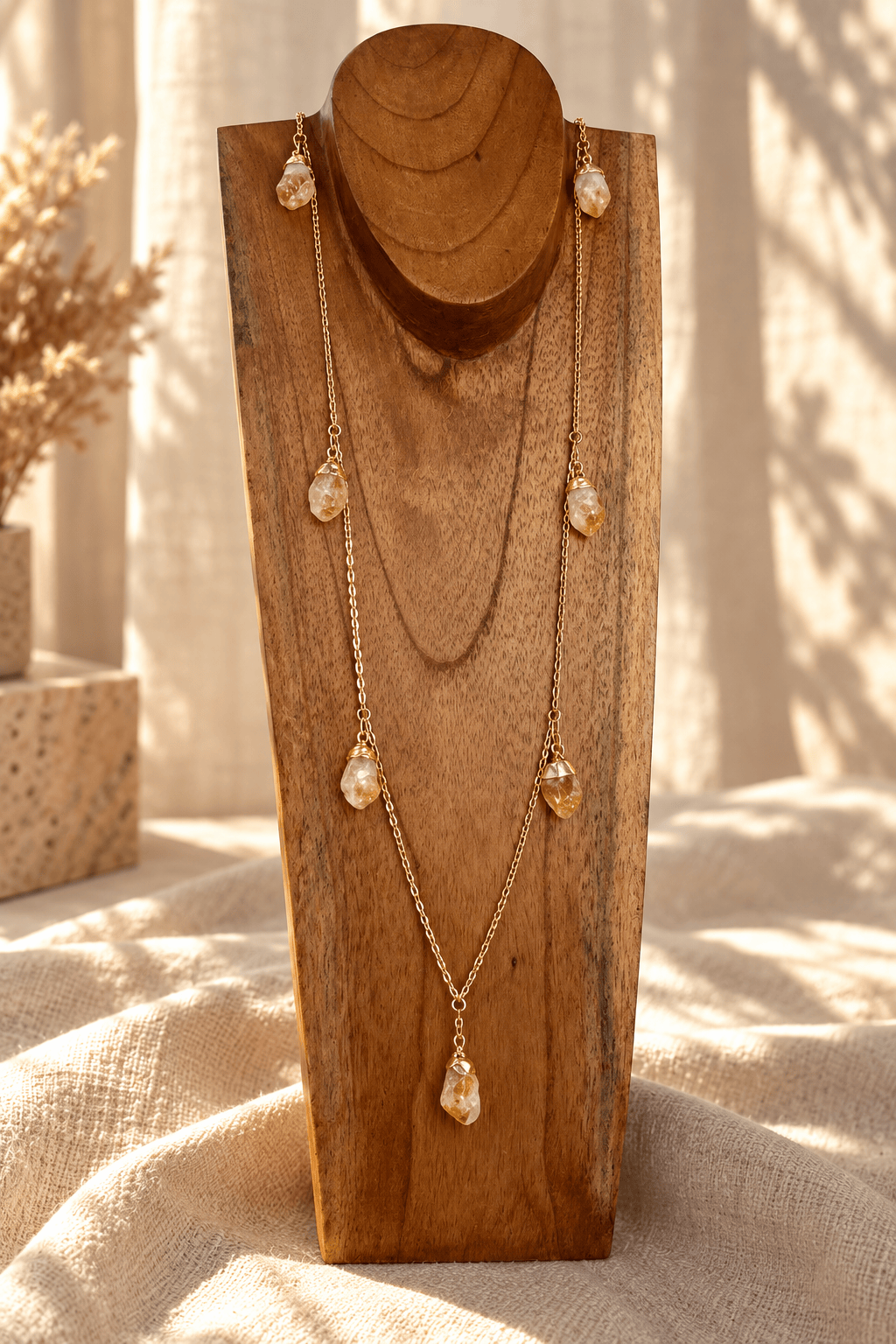 Seven-stone Citrine convertible necklace worn long on a wooden jewelry stand