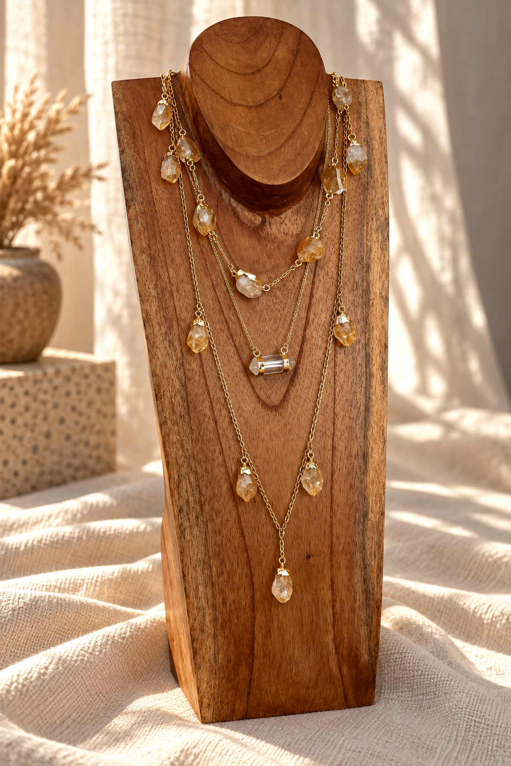 Seven-stone Citrine necklace doubled into a layered gold crystal necklace on wooden jewelry stand