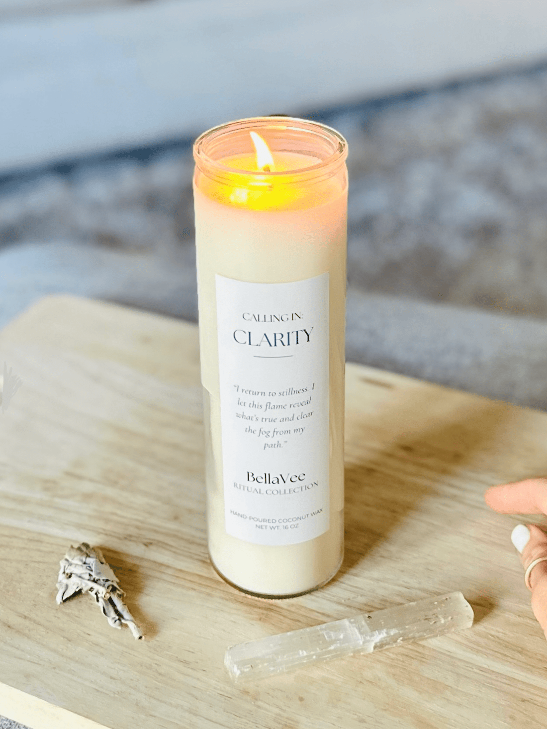 Lit Clarity Ritual Candle by BellaVee radiating soft, calming light in a serene home environment