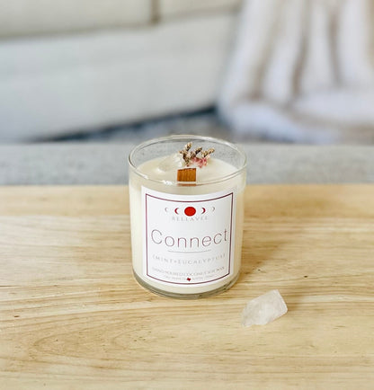 Connect CBD Crystal Candle in a reusable glass jar, styled with eucalyptus leaves and crystals, highlighting its clean aesthetic and holistic wellness purpose.